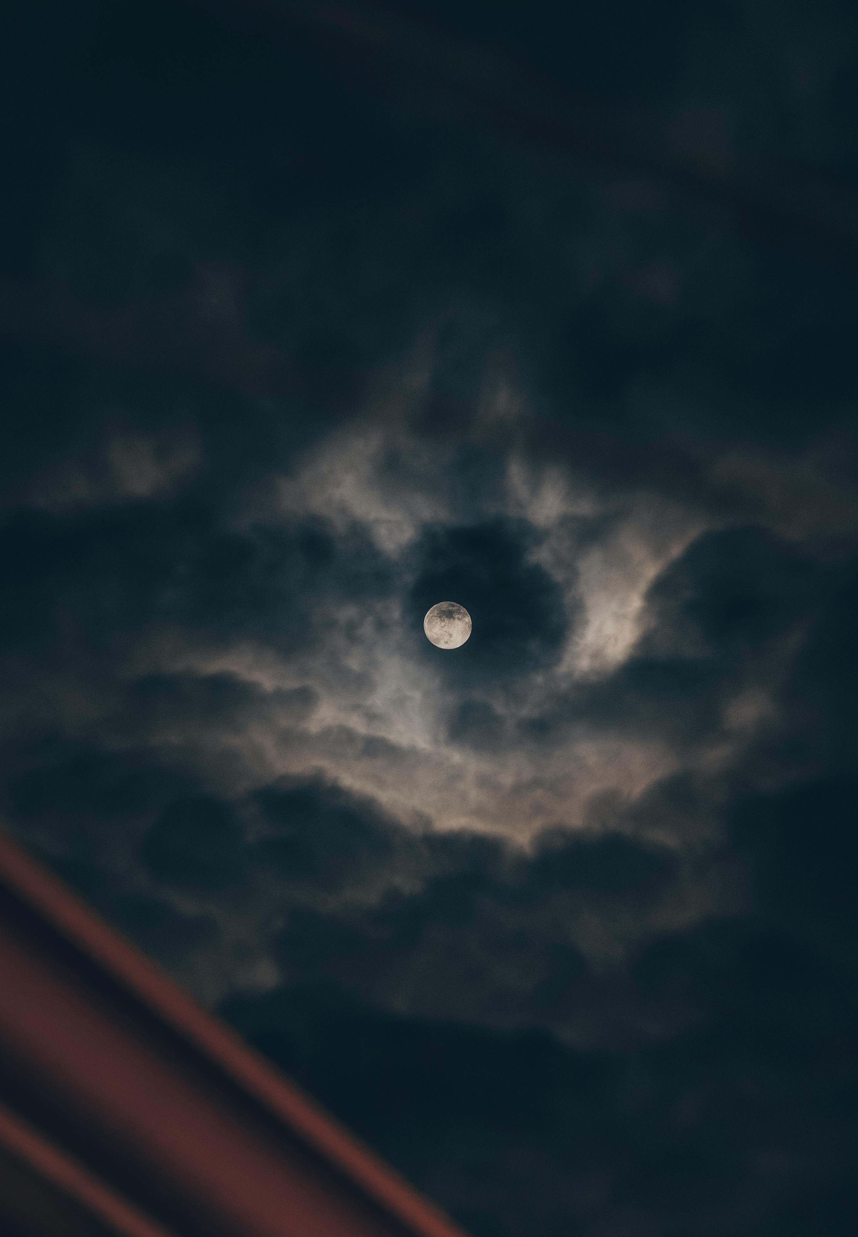 Full Moon among Clouds on a Night Sky