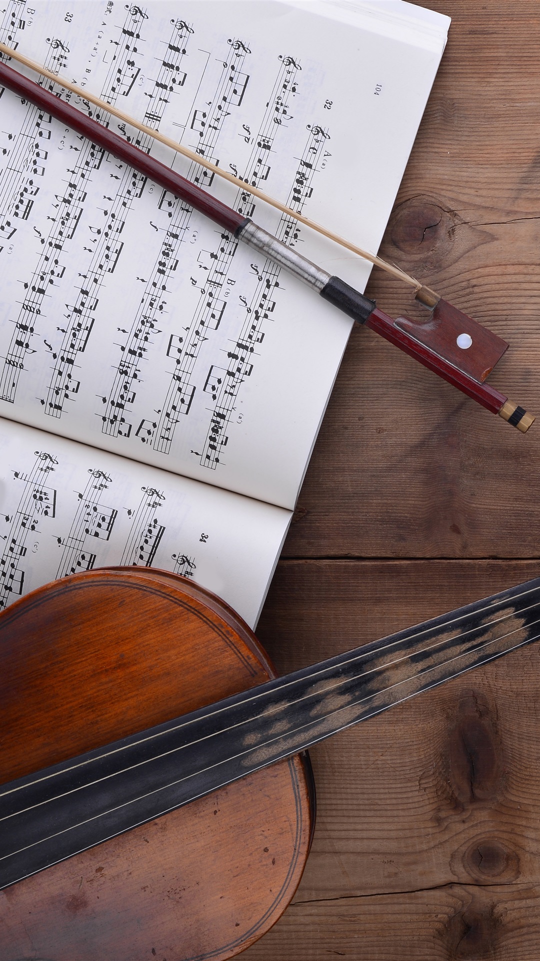 Violin, music score, wood table