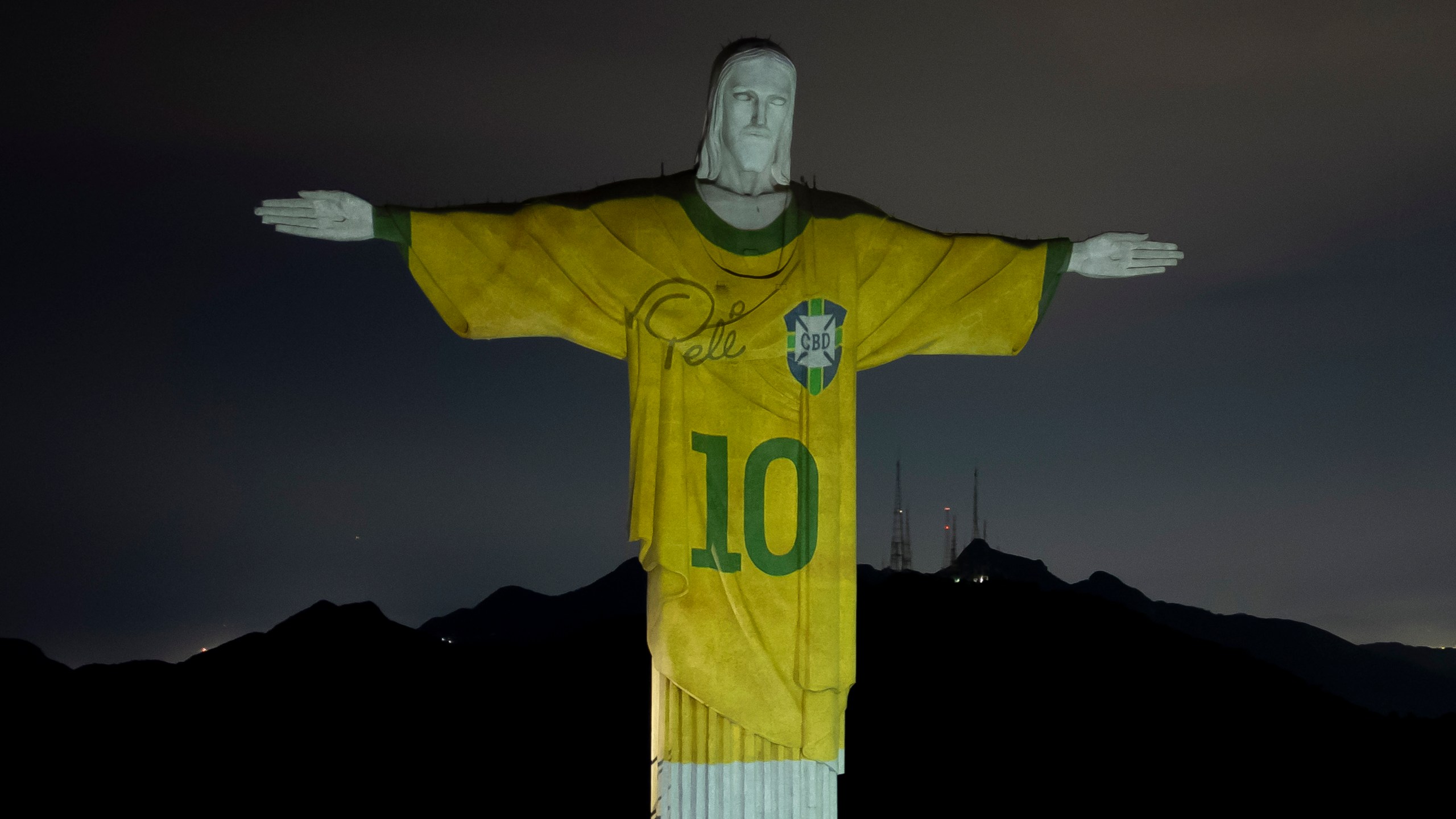 Christ the Redeemer lit in Pele shirt