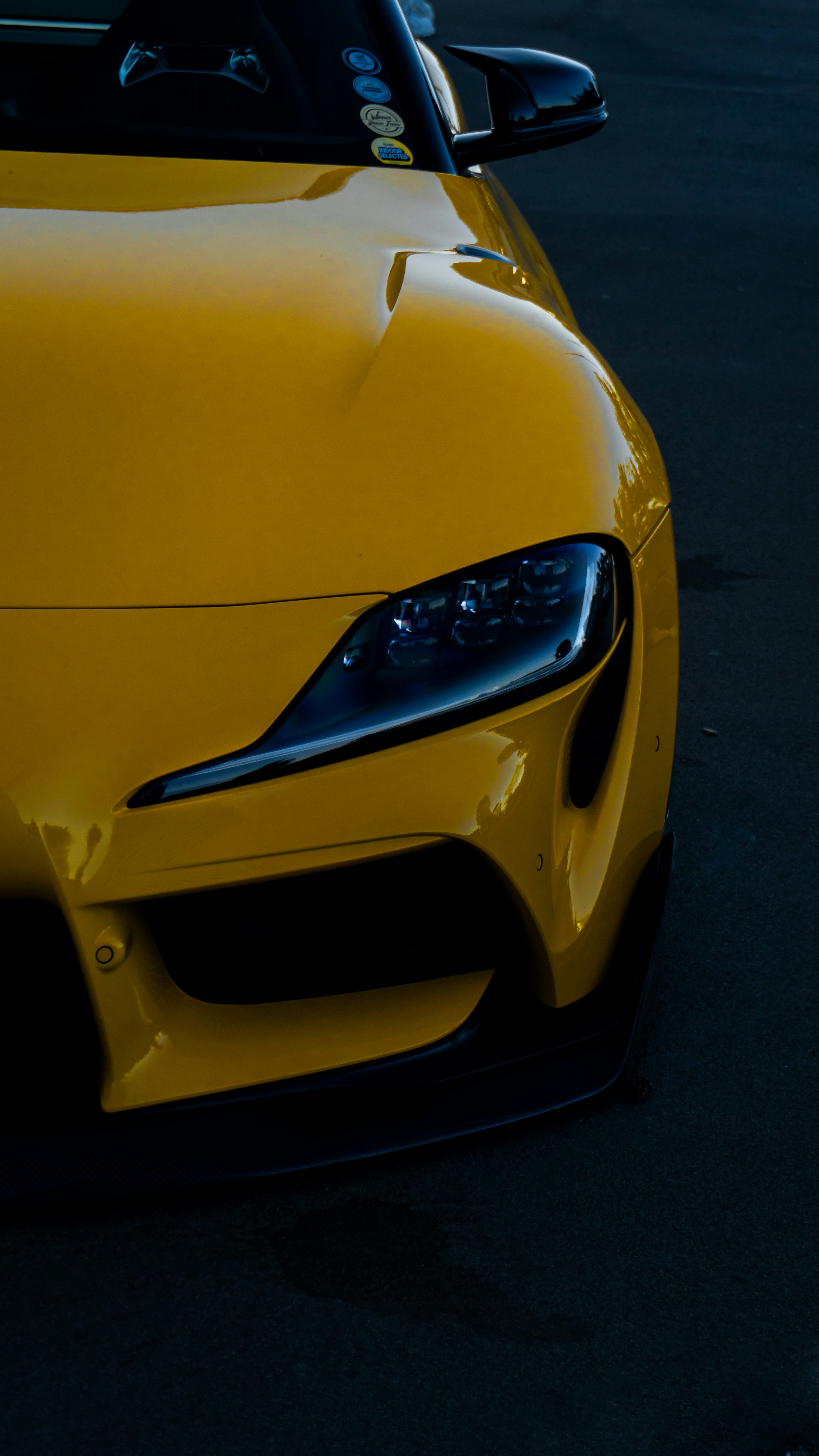 A yellow sports car parked in a parking