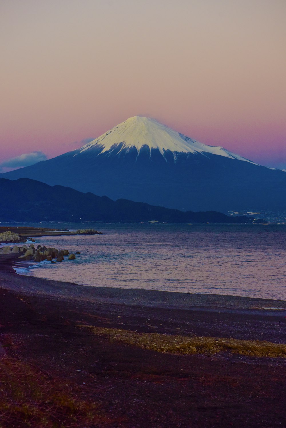 Brown sand beach near mountain under