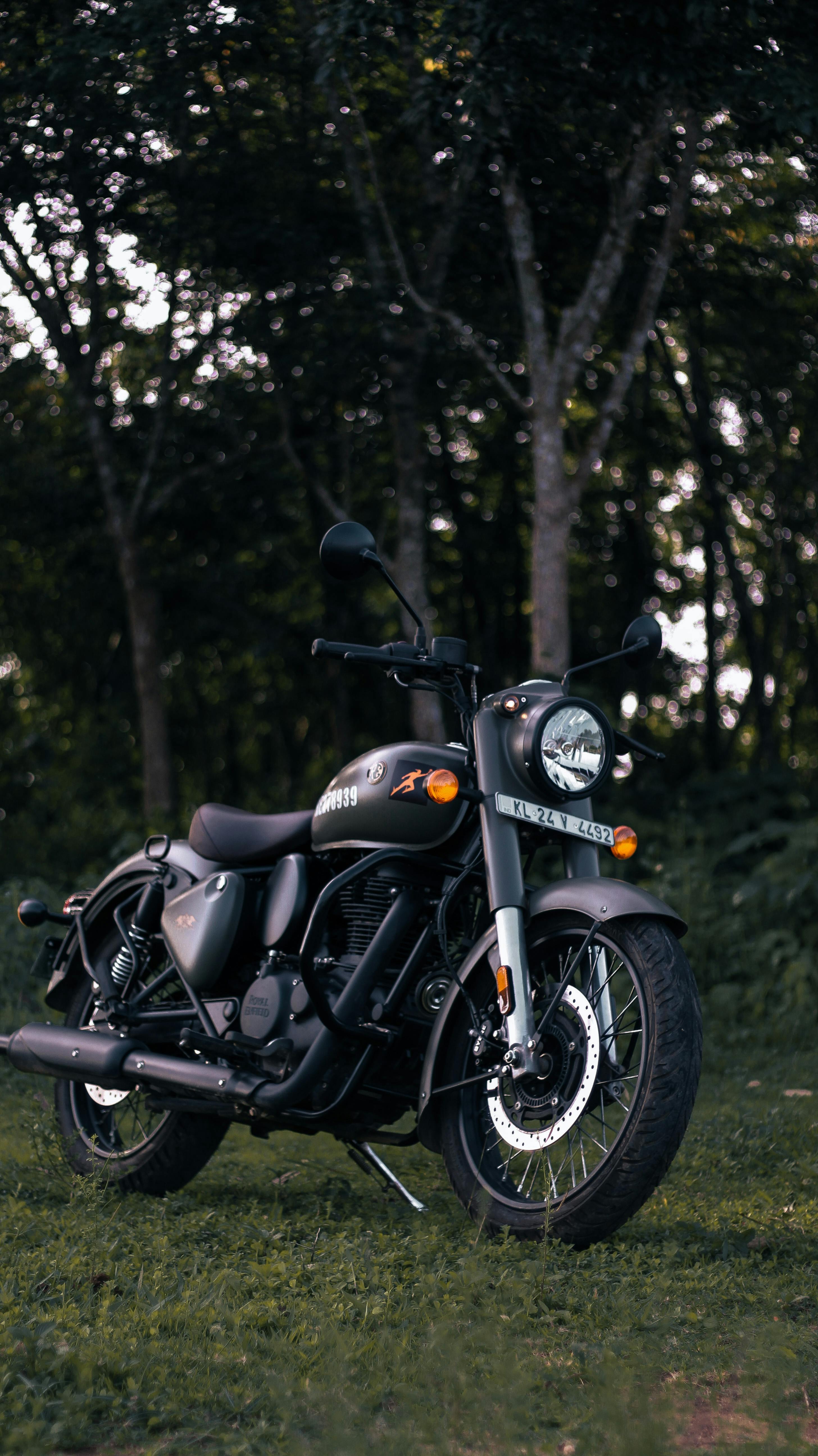 Full HD Black Royal Enfield Wallpaper A Royal Enfield Motorcycle Parked In A Park · Free Stock