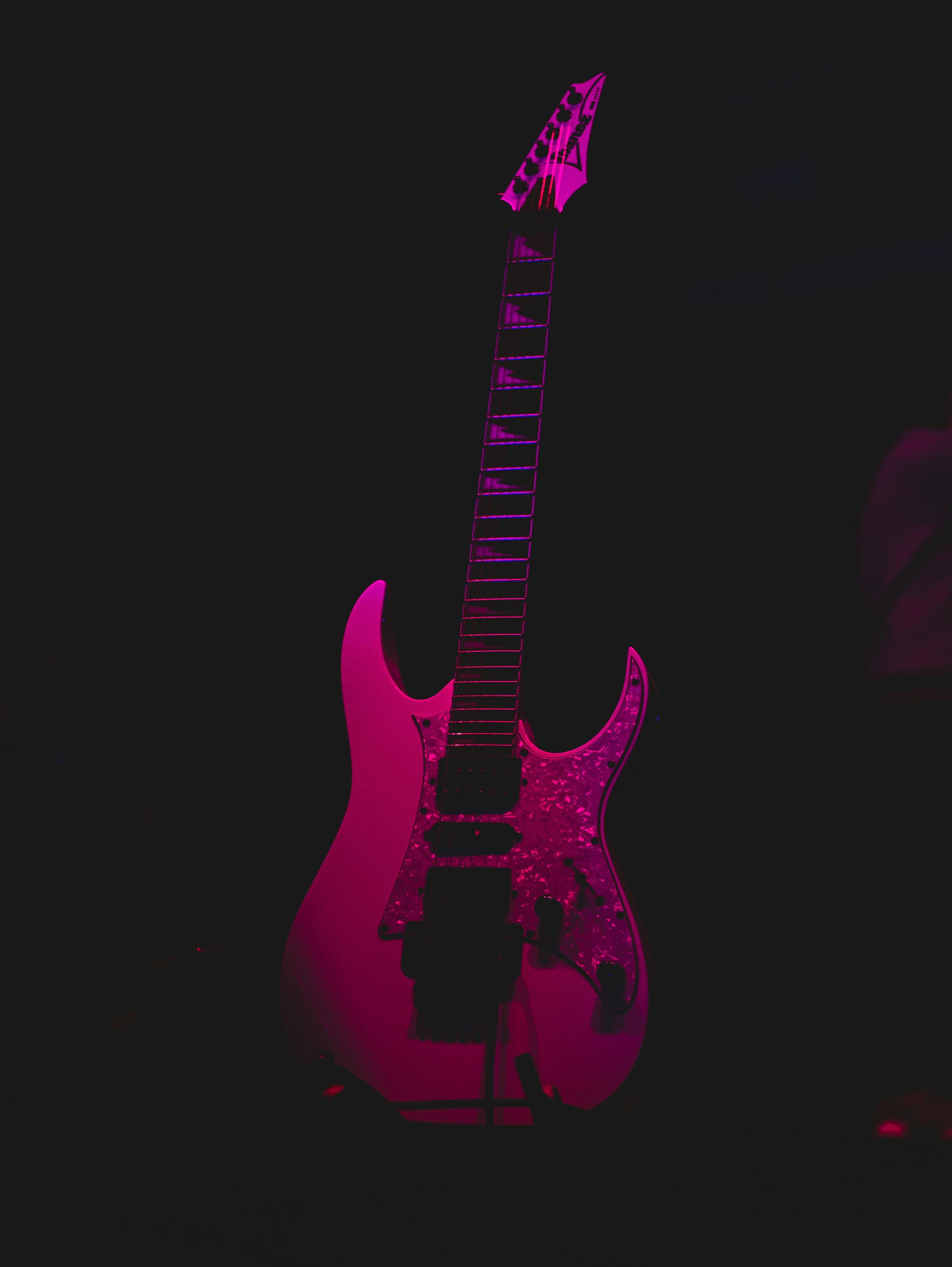 Pink and black electric guitar photo