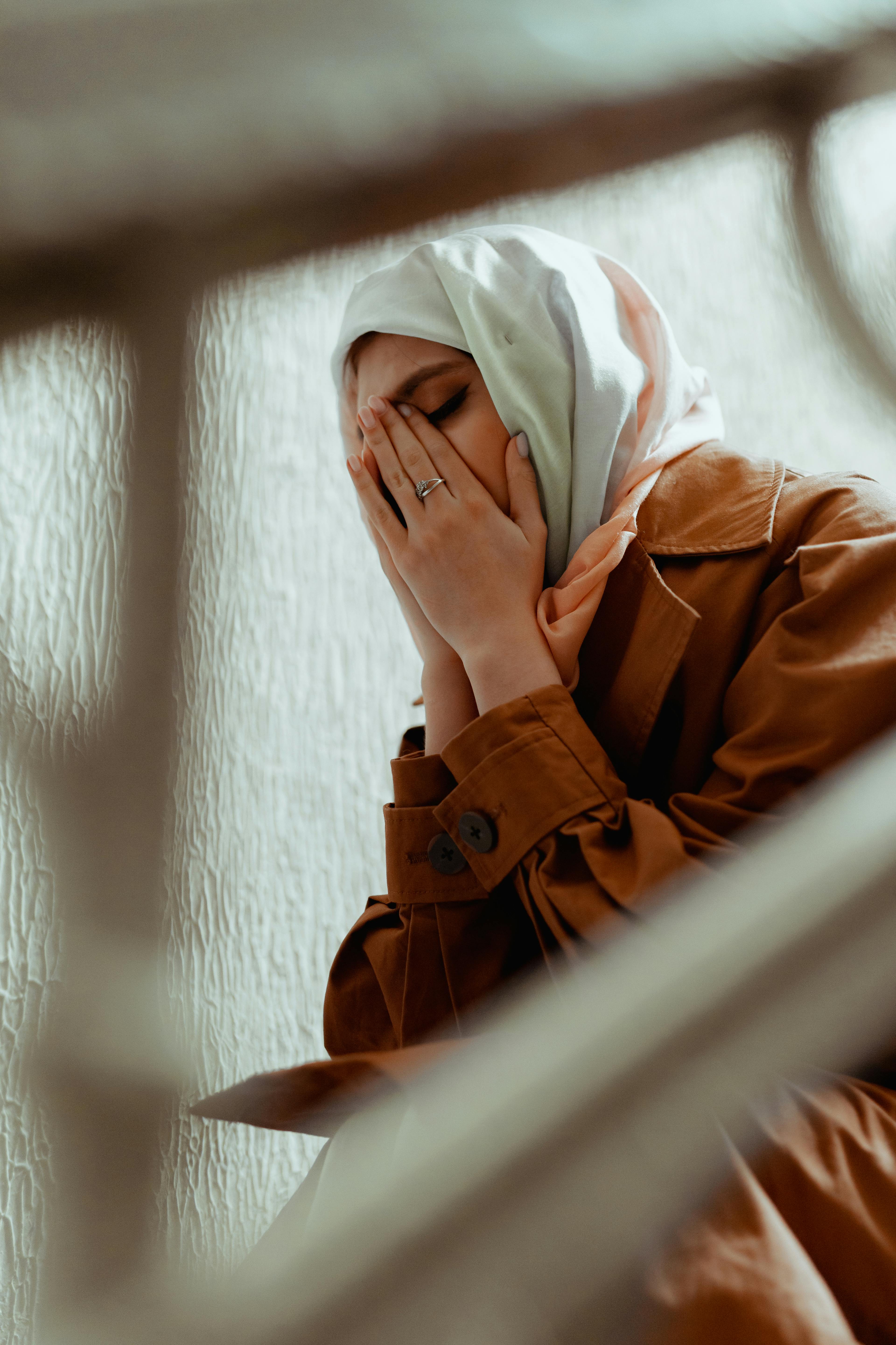 A Crying Woman in a Hijab and a Brown