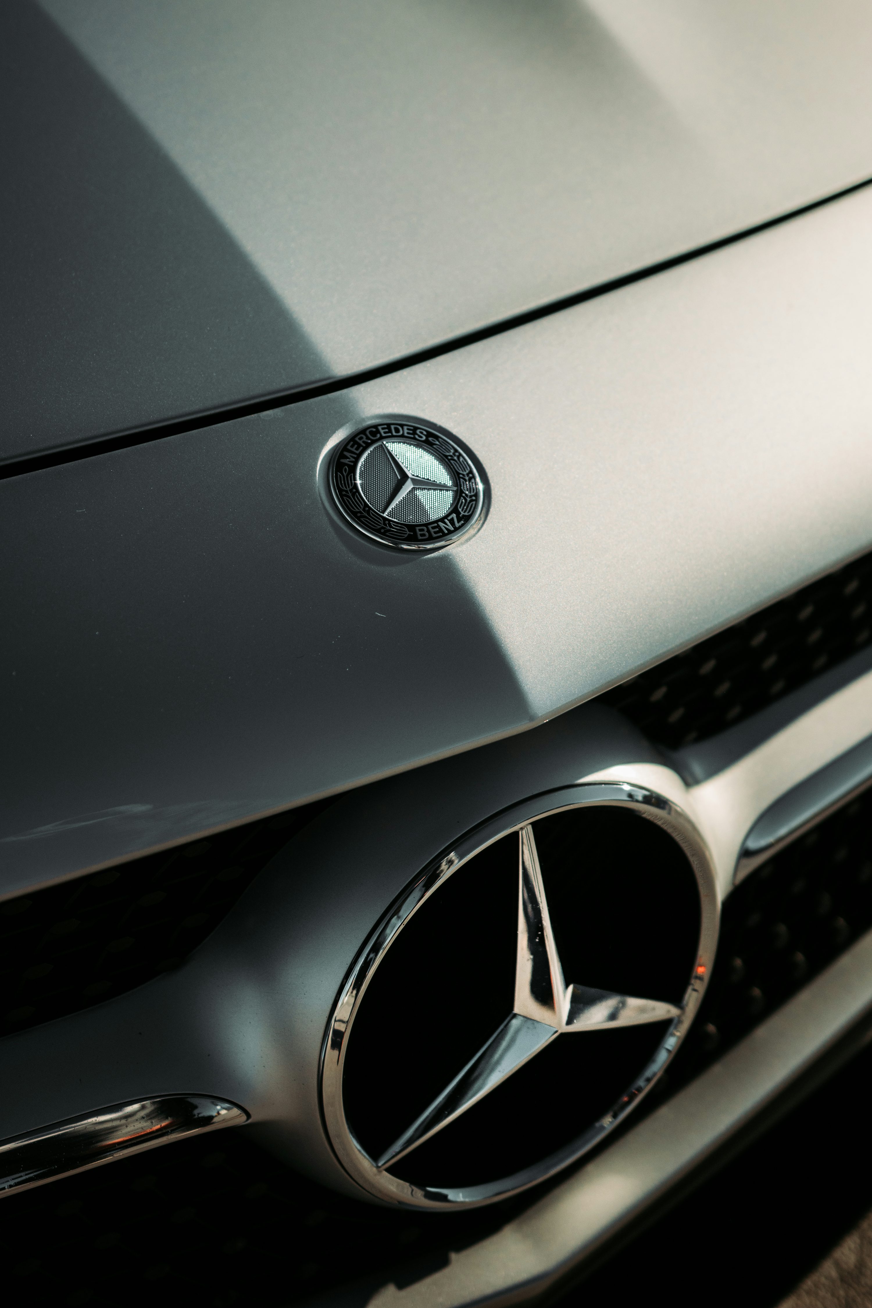 Silver mercedes benz emblem on gray car