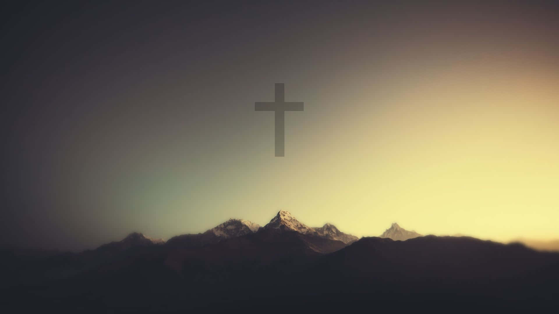 Download A Cross Is Shown On Top Of A Mountain Wallpaper