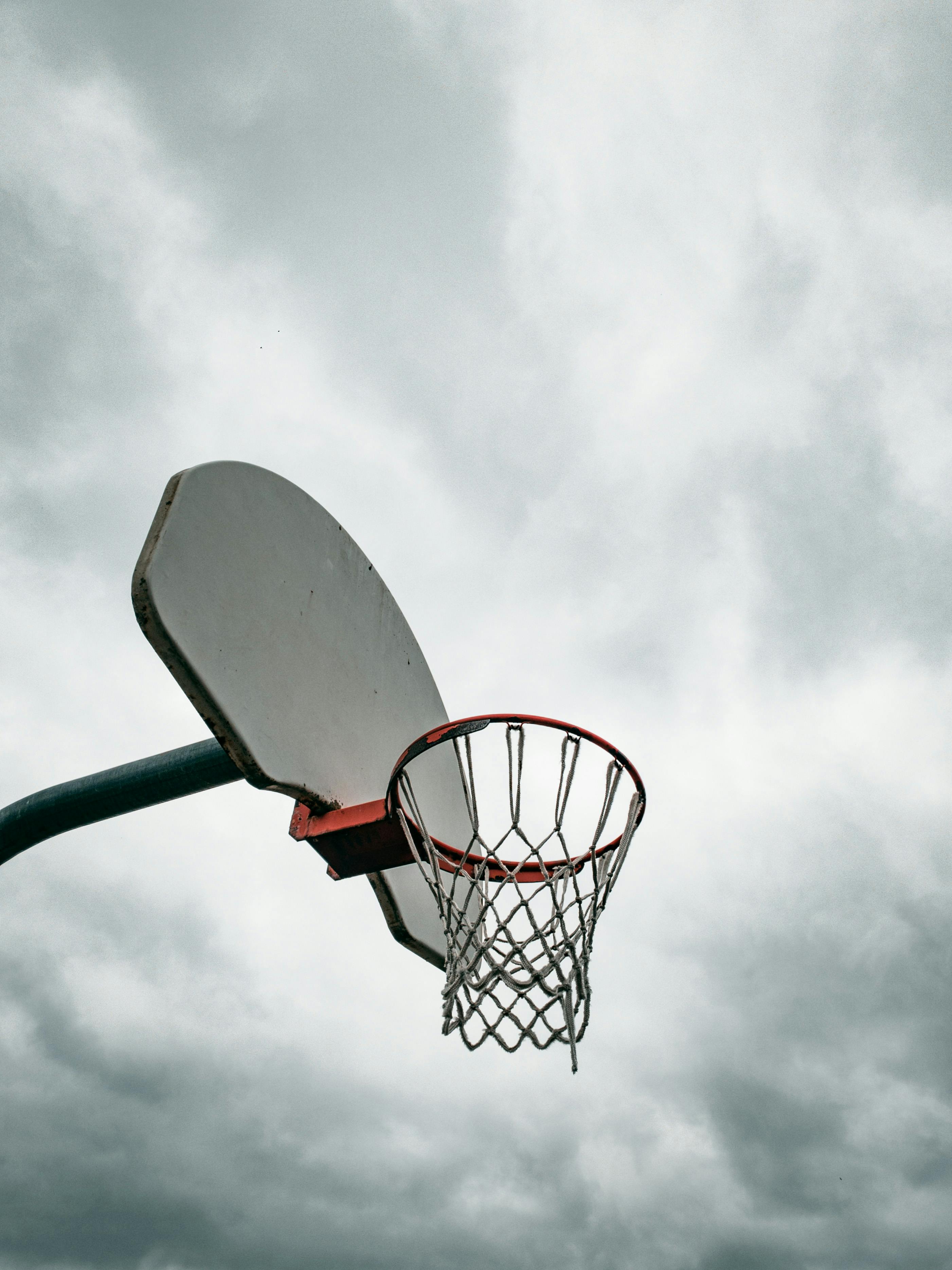 Basketball hoop against cloudy sky