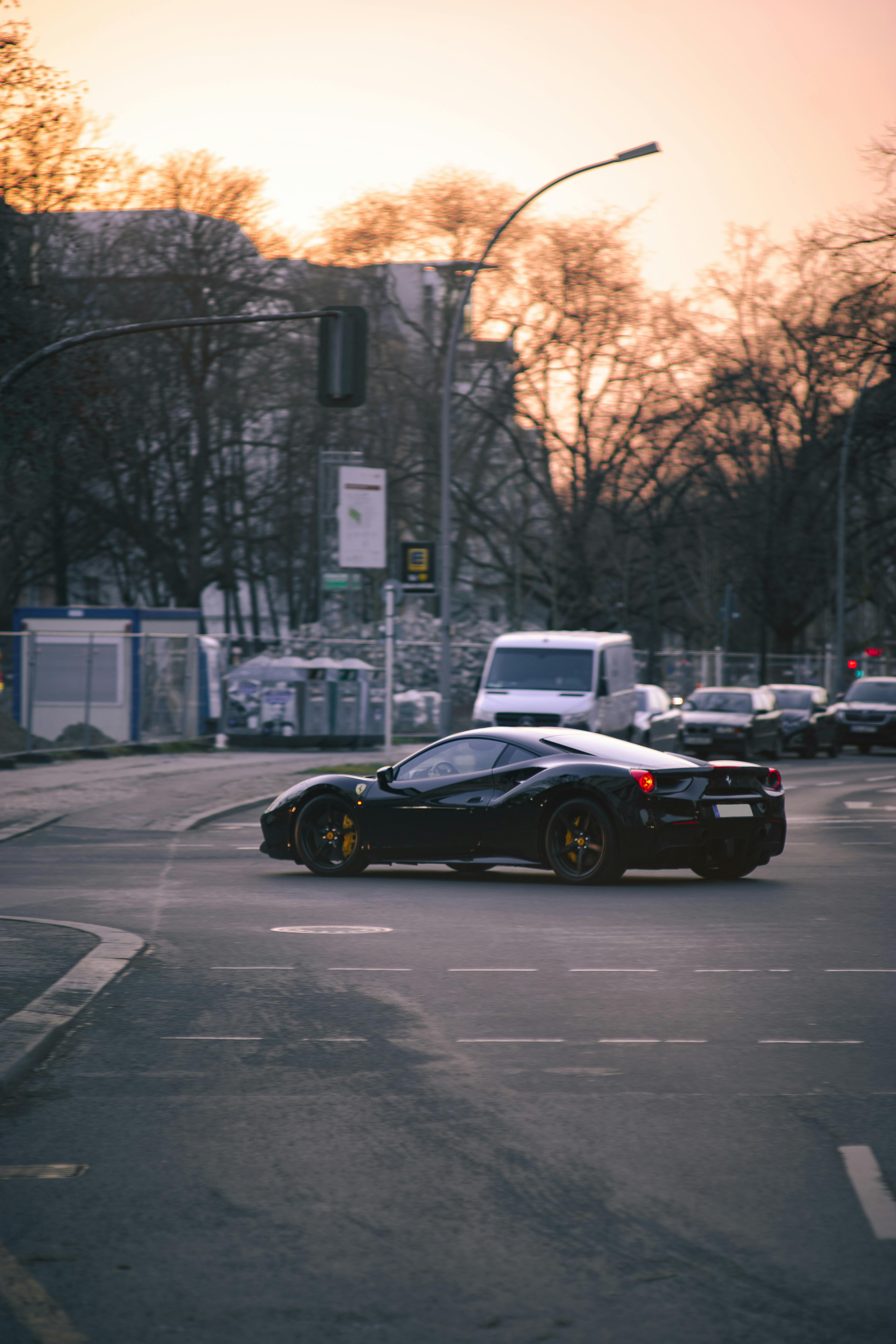 A Black Ferrari Car on the Road · Free