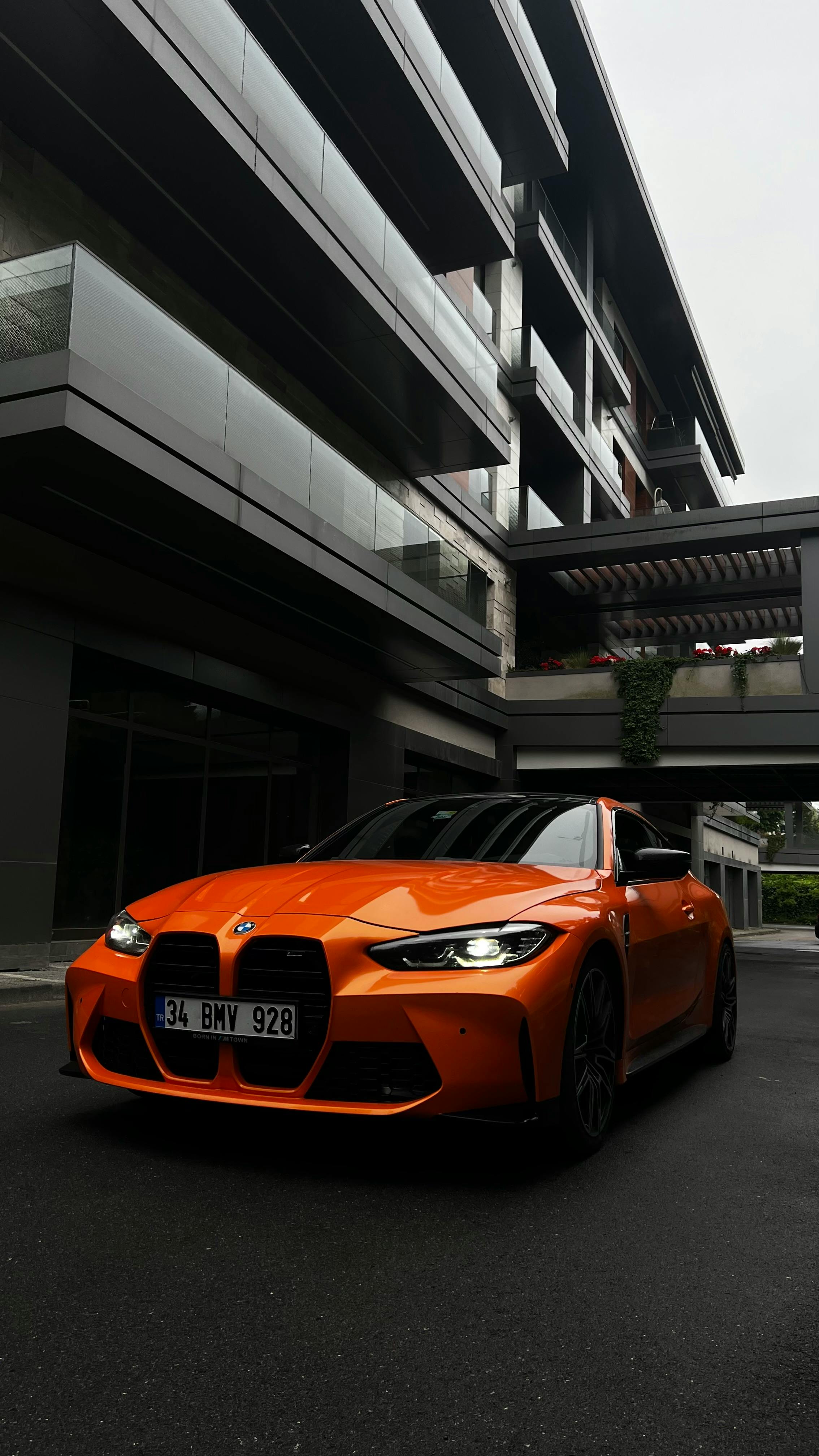 View of an Orange BMW M4 in front of a