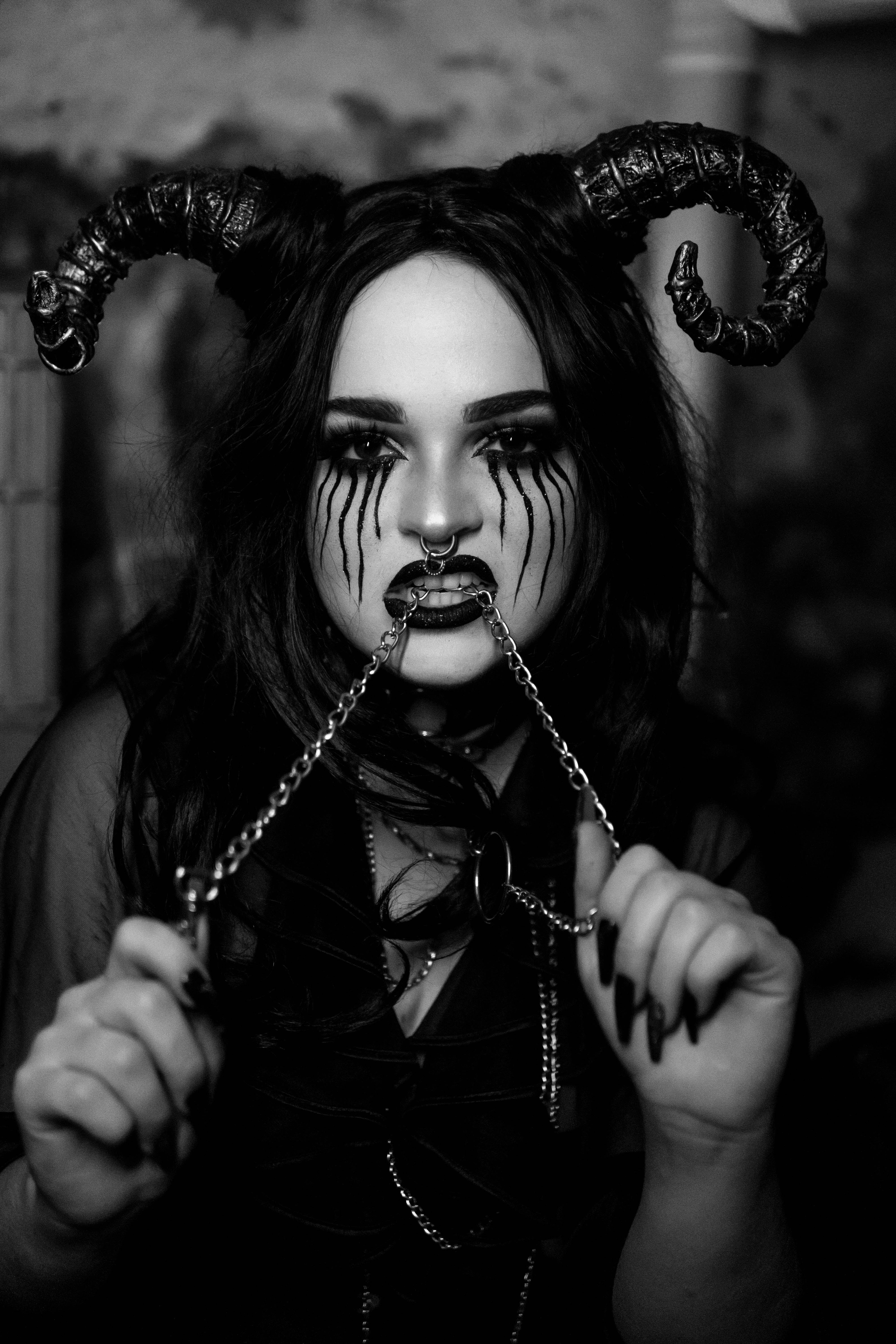 Satanic Costume Biting a Chain