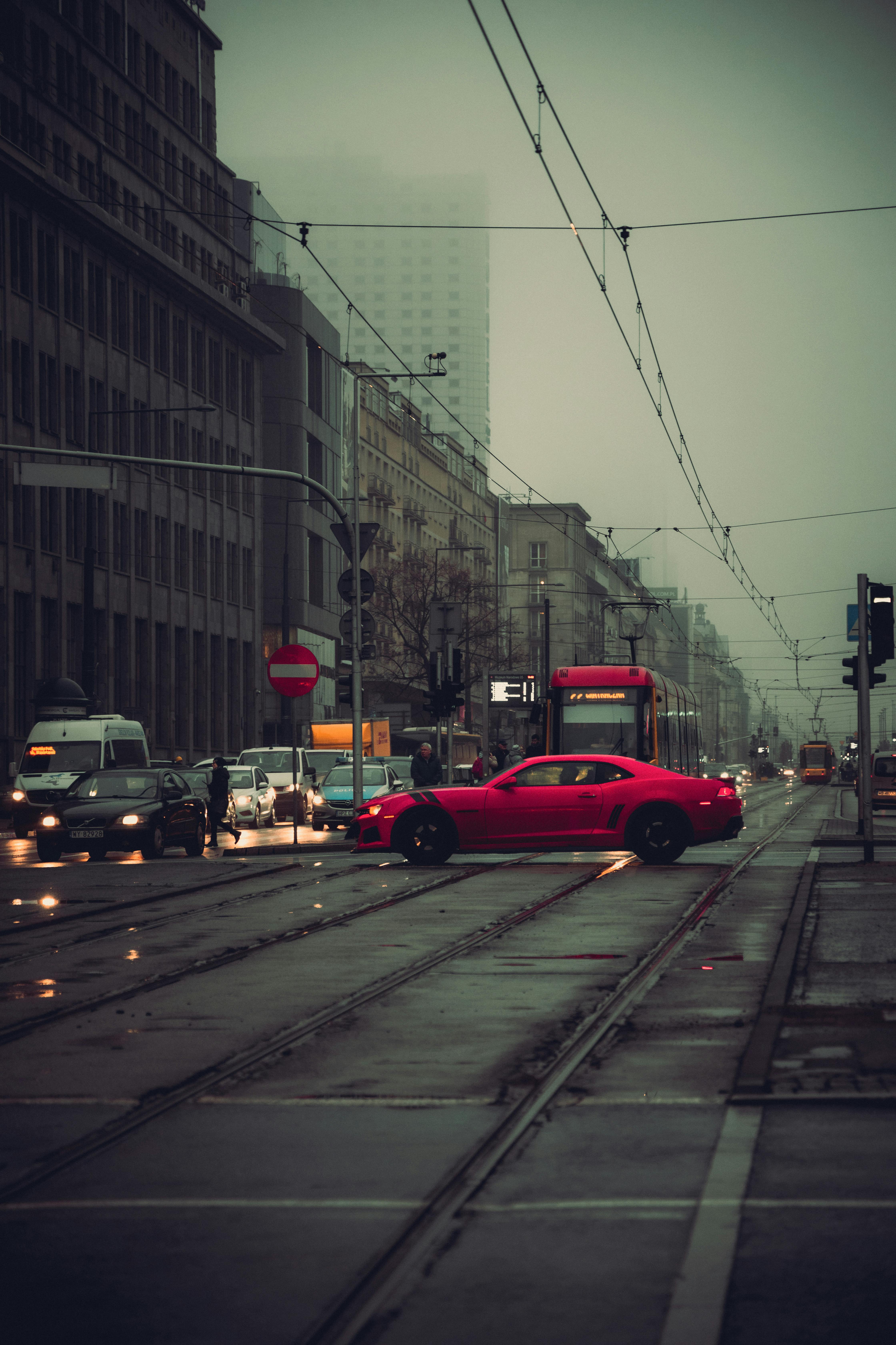 car driving down a street in the rain