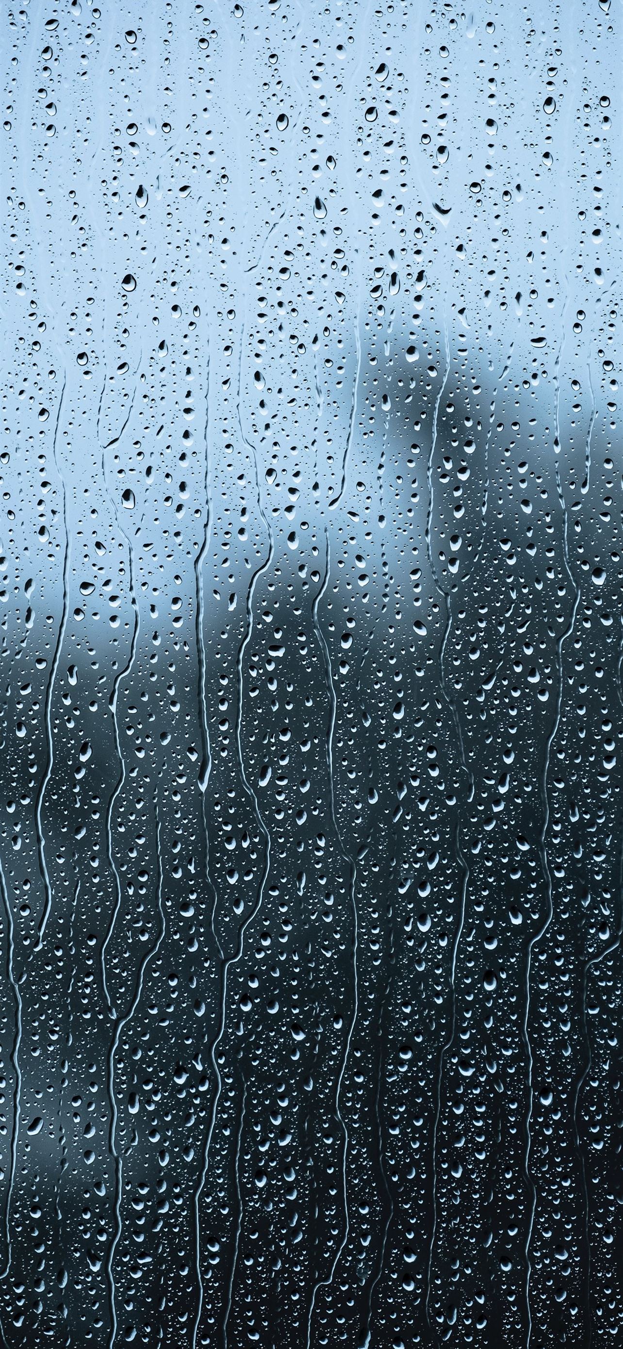 rain drops on a window with a building