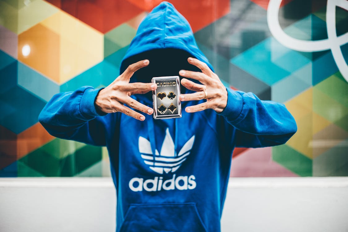 Man in Blue Adidas Hoodie Doing Magic
