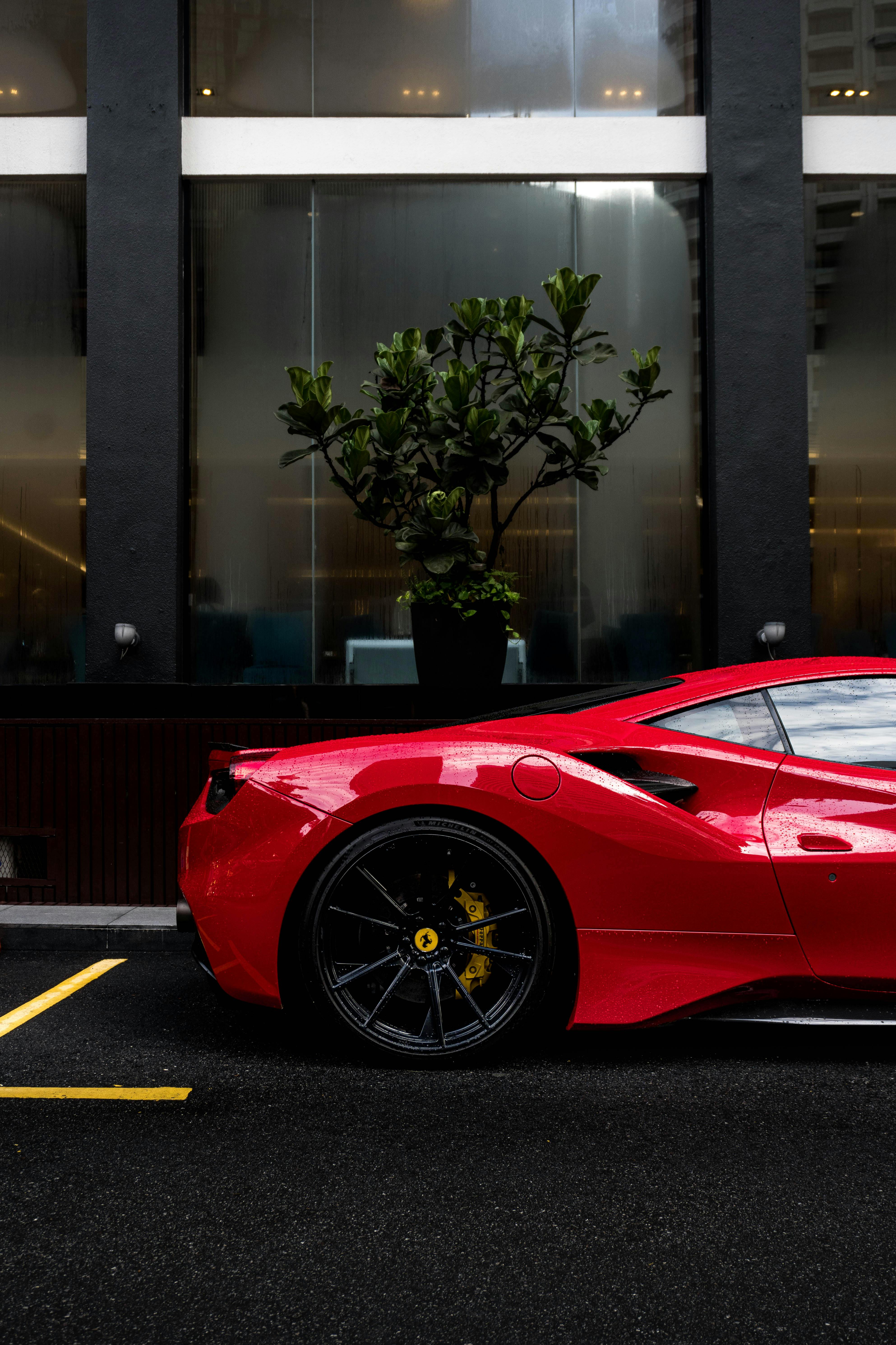 Red Ferrari Parked on the Road · Free