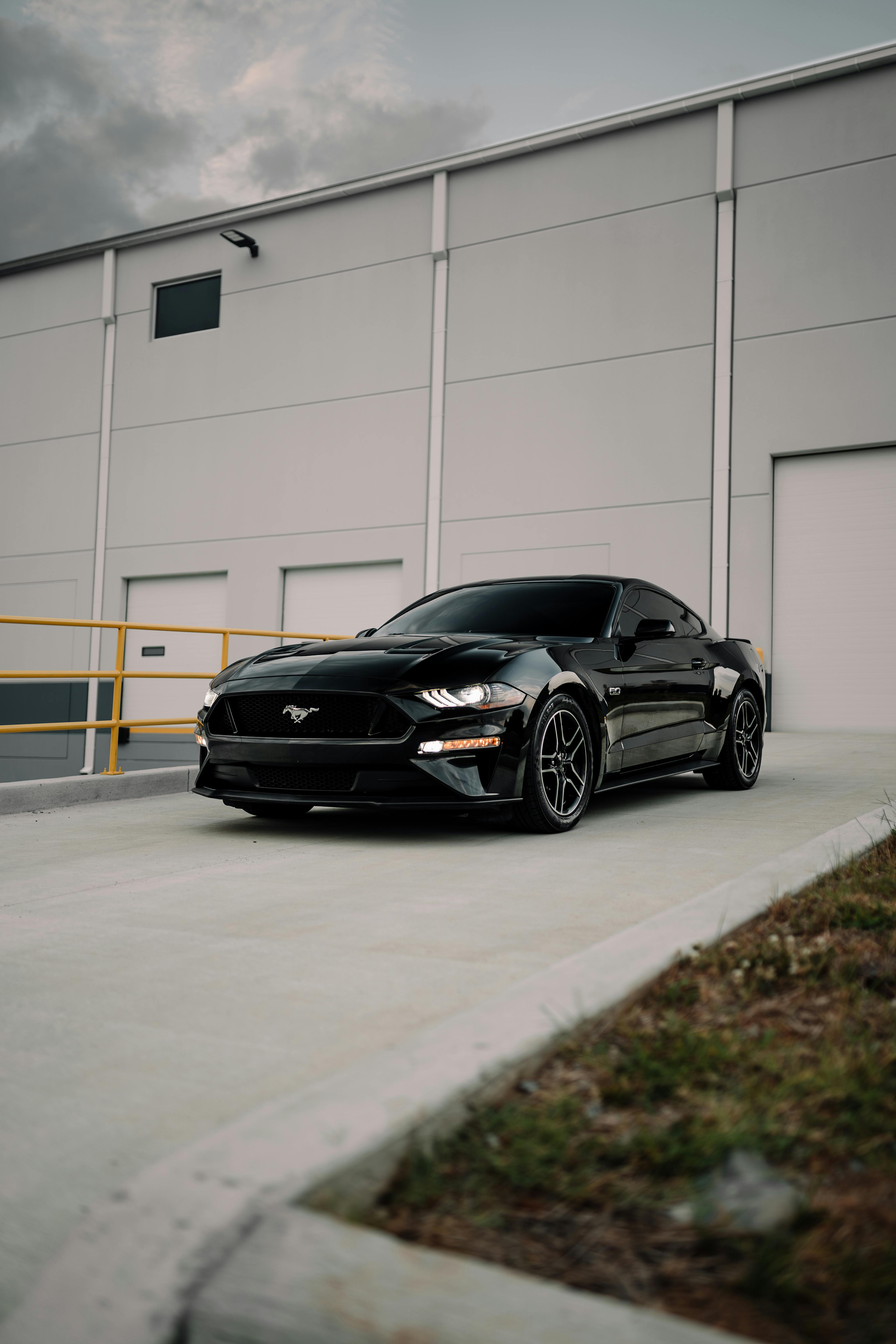 Black Ford Mustang near Building · Free
