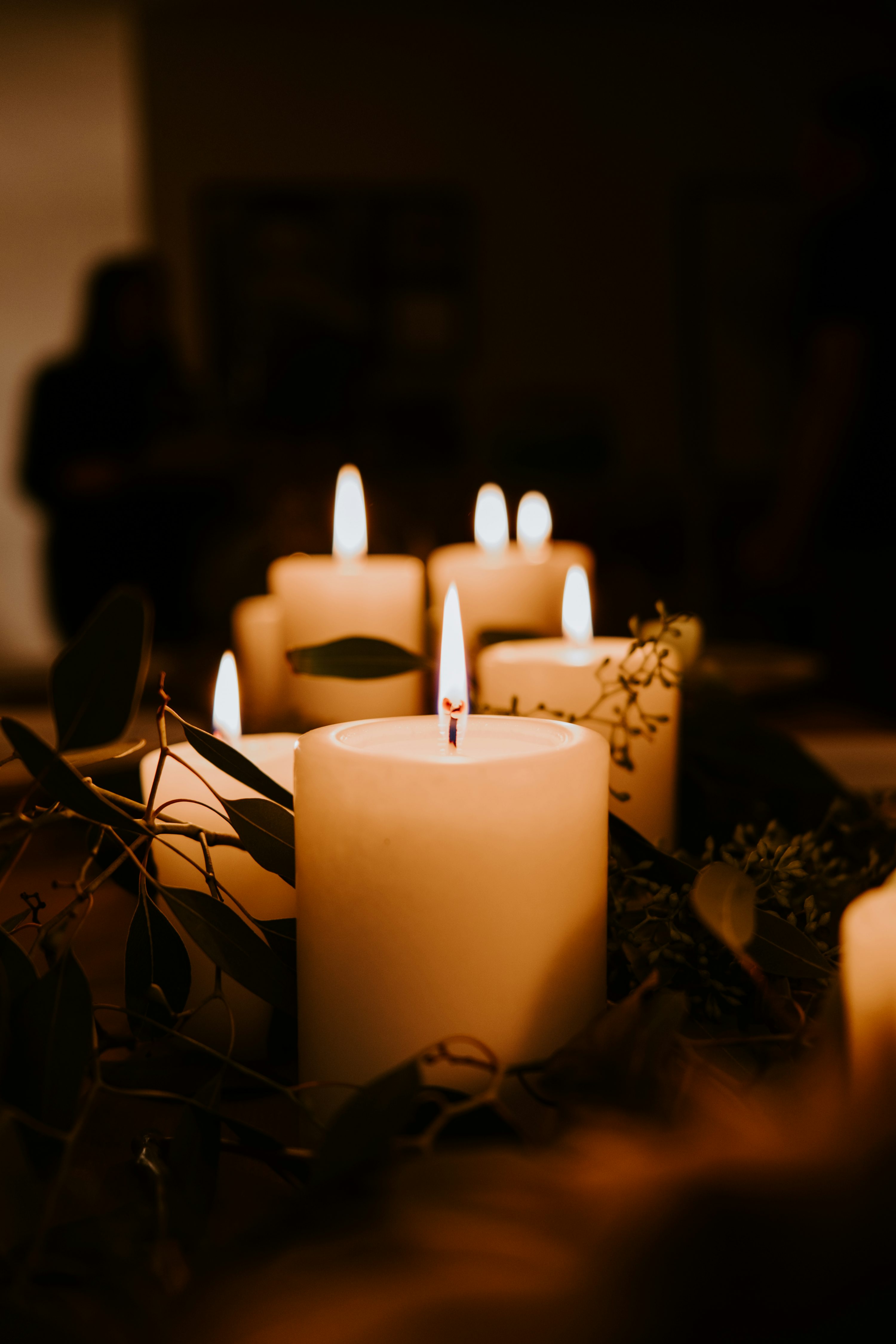 White pillar candles on black holder