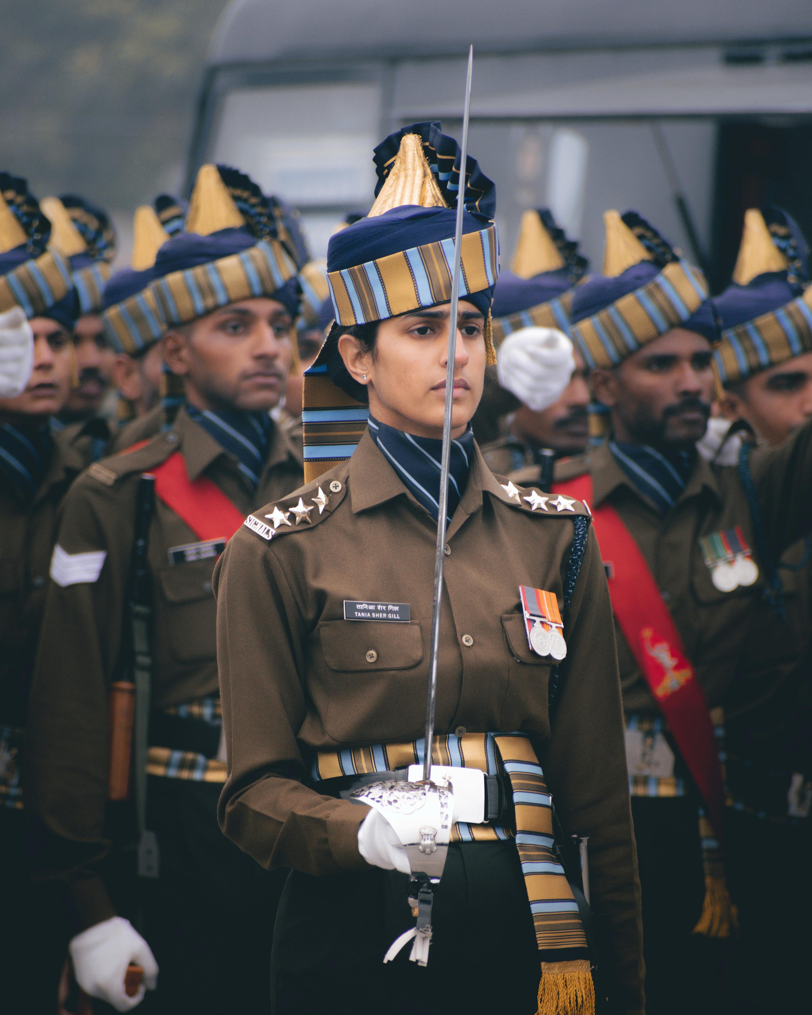 A Man in Brown Uniform Holding a Sword · Free