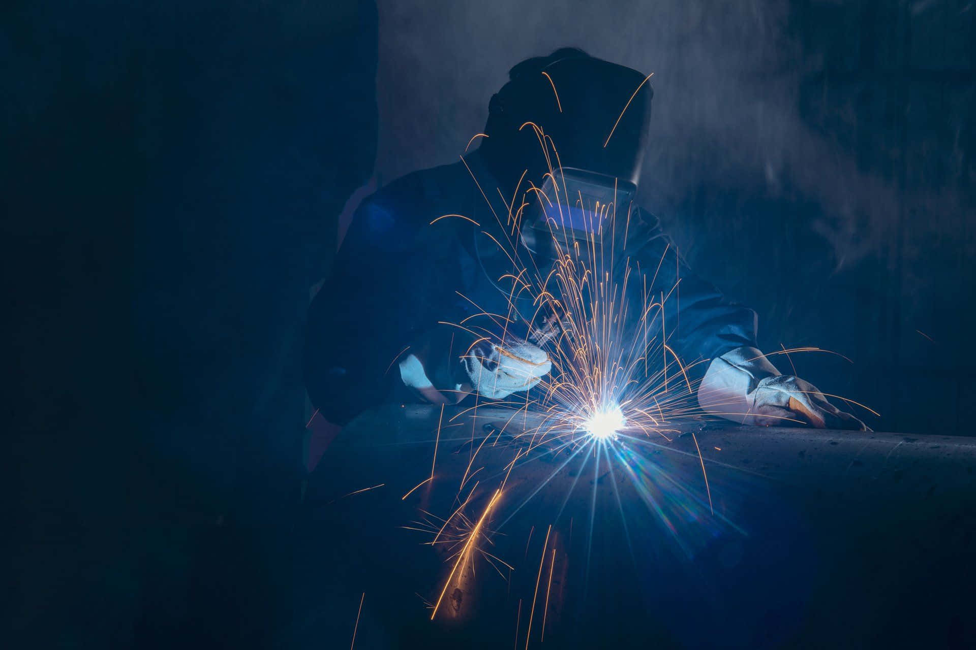 Download A Welder Is Working On A Metal