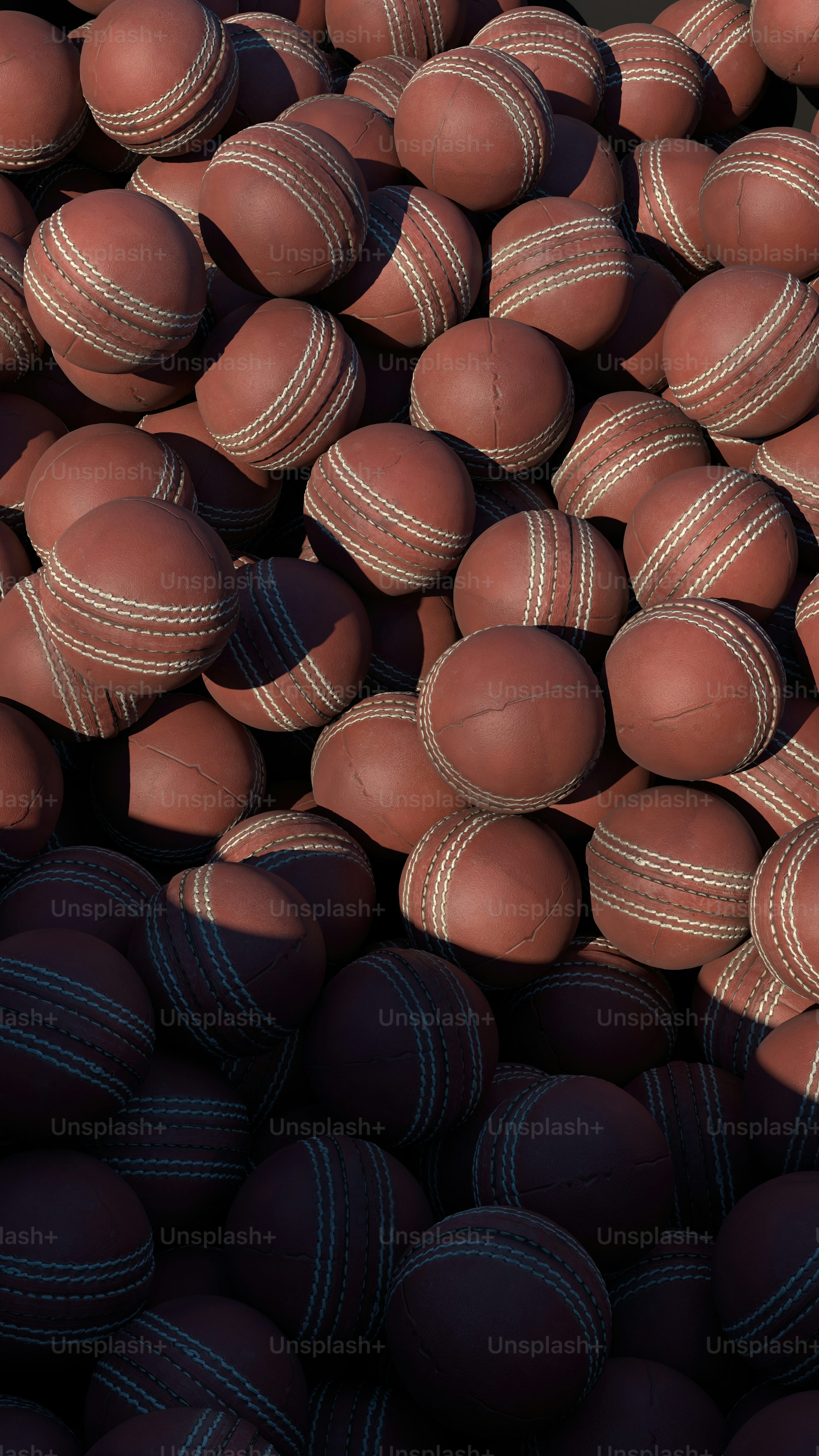 pile of brown balls with white stitchs