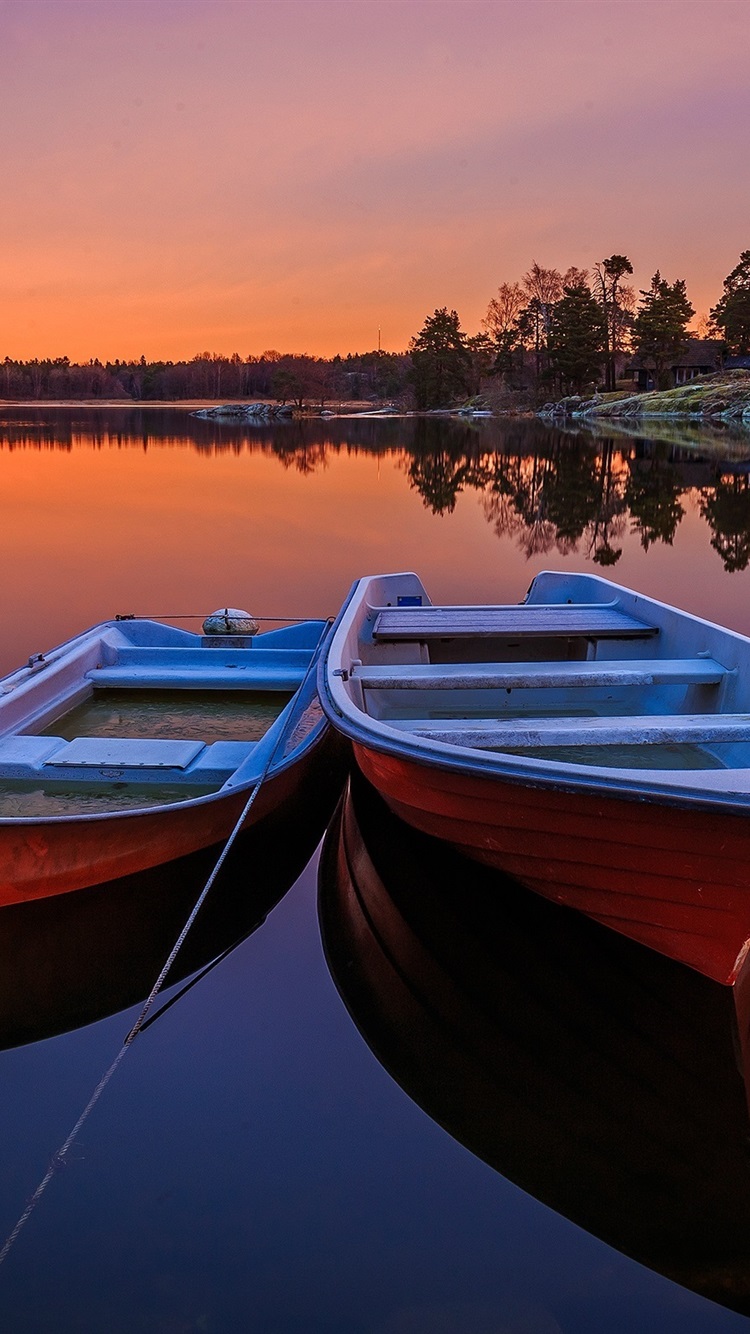 Sweden, two boats, lake, trees, sunset