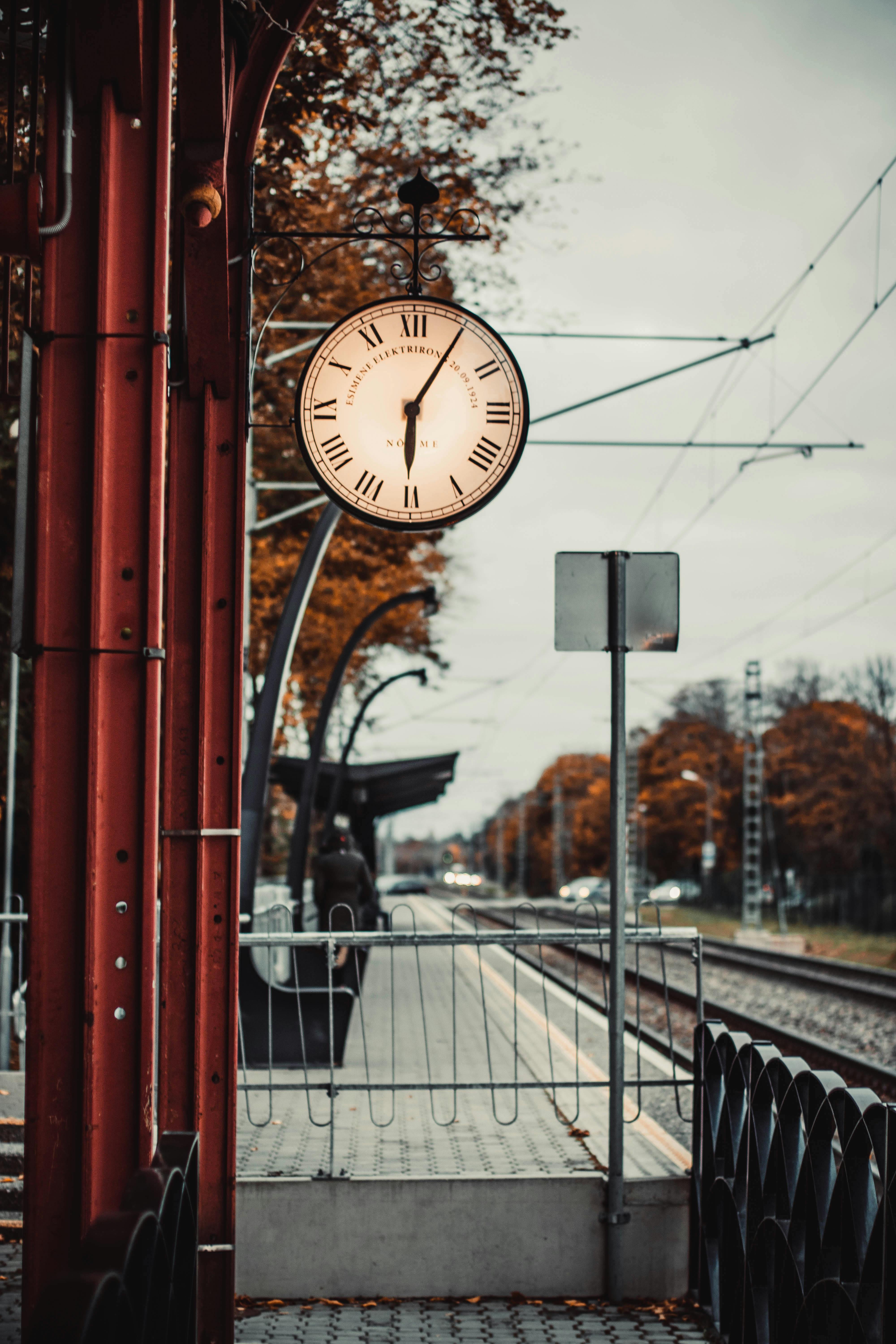 Old clock on train station in autumn