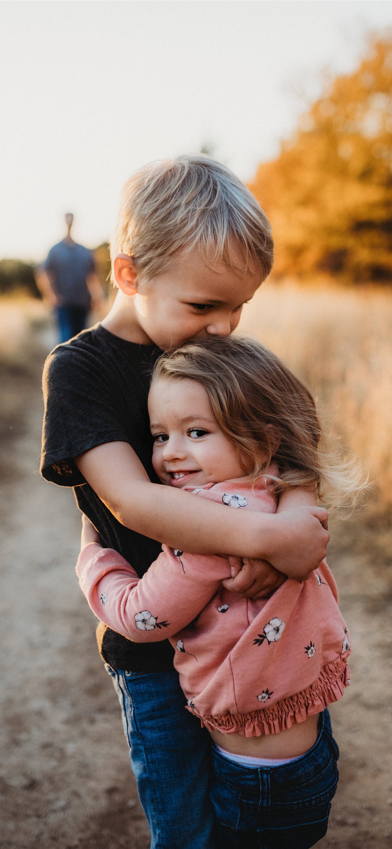 boy in black t shirt hugging girl
