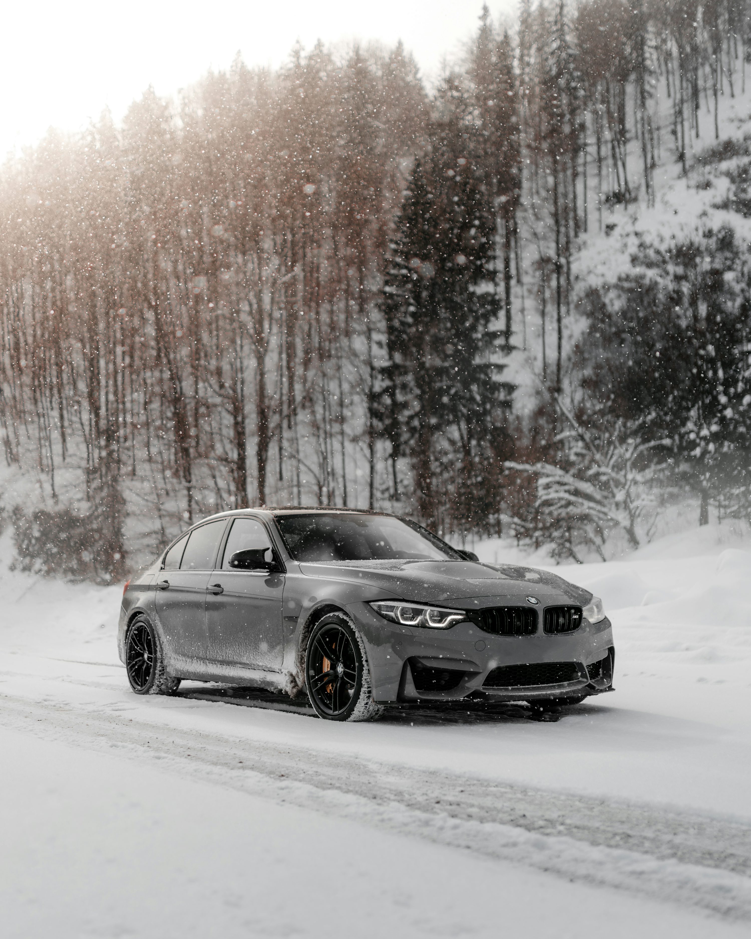 Black bmw coupe on snow covered road