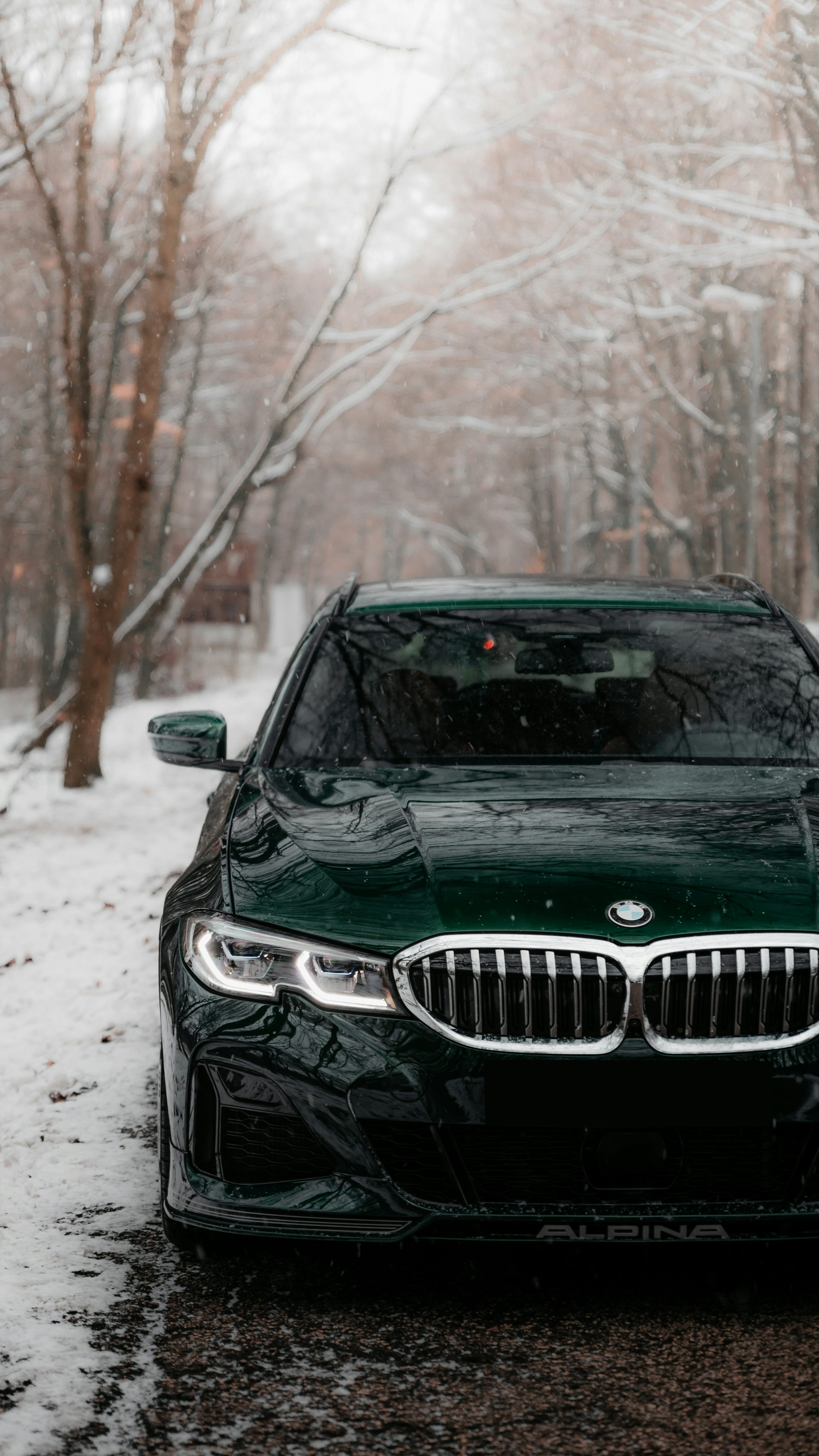 Black bmw car on snow covered ground
