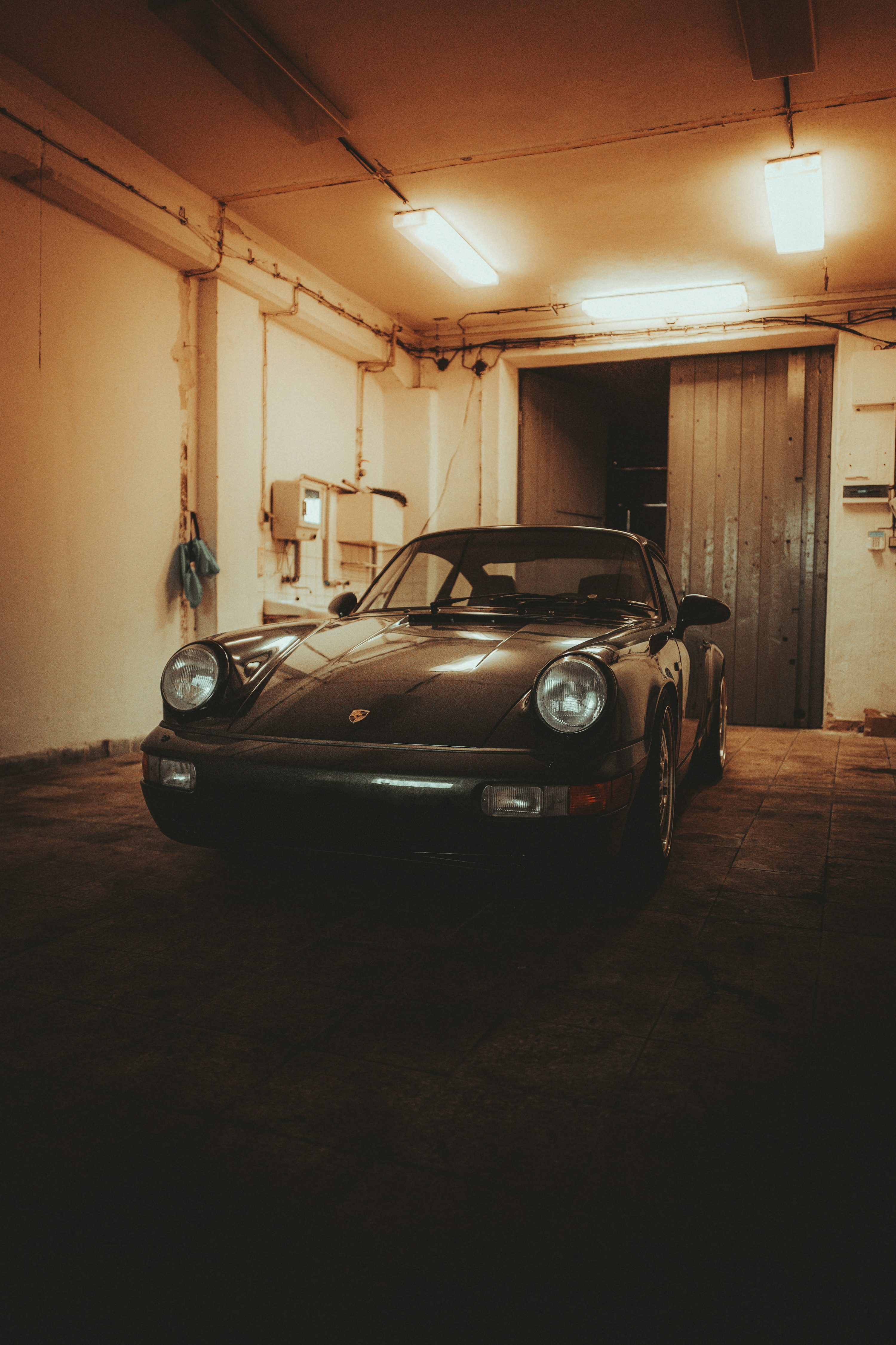 Black porsche 911 parked in garage