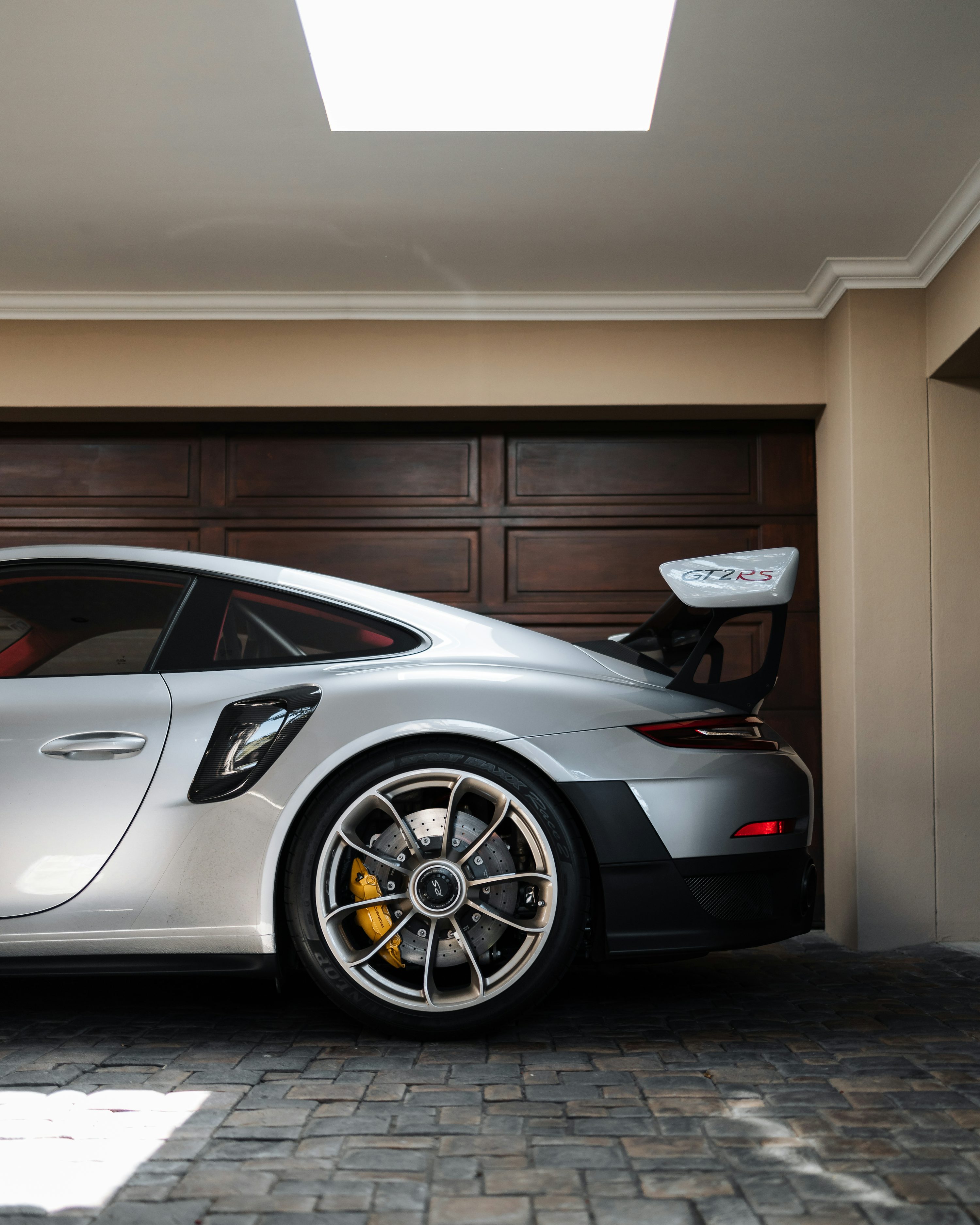 A silver sports car parked in a garage
