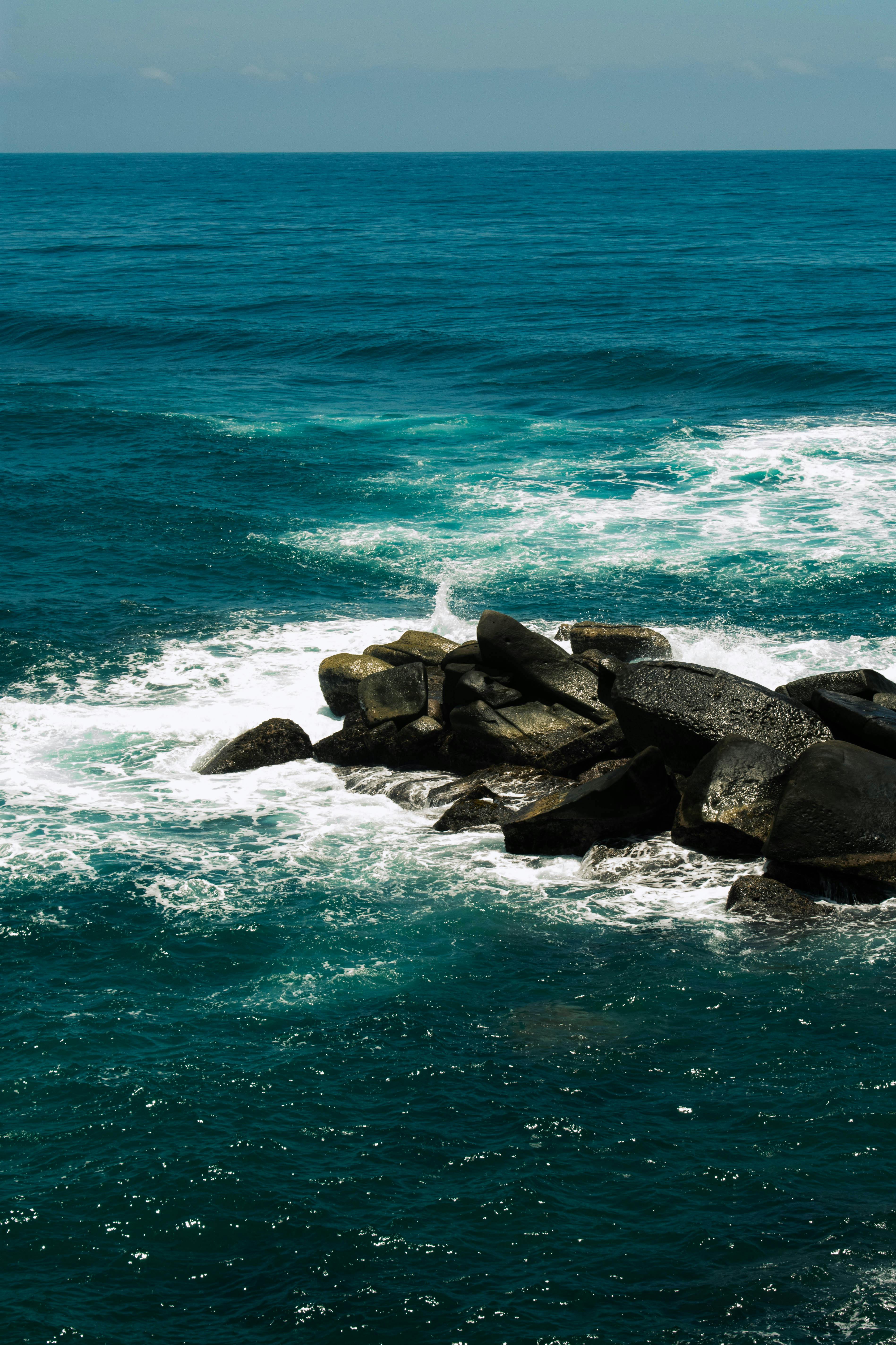 Black Rocks on Blue Body of Water