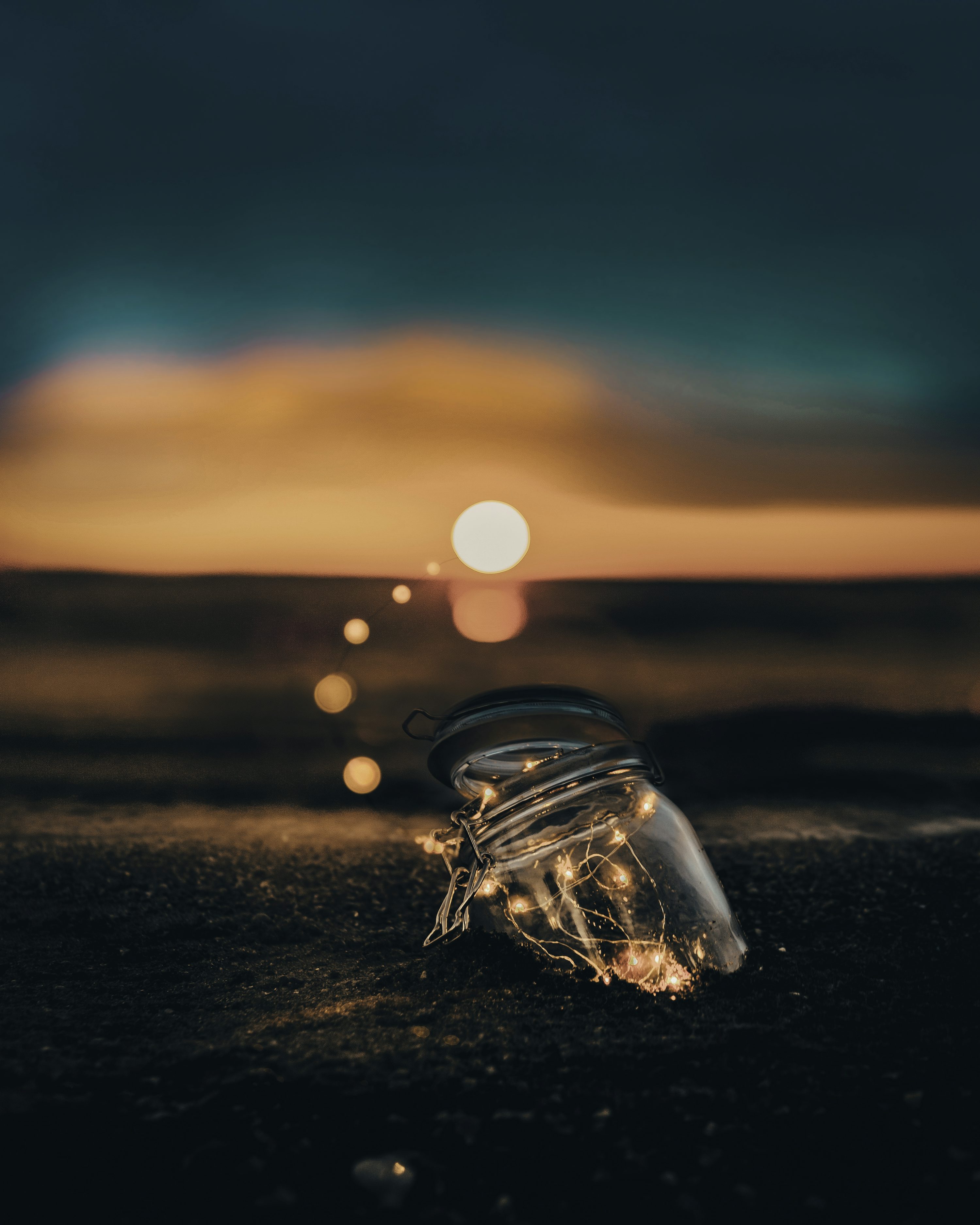 Clear glass jar on sand photo