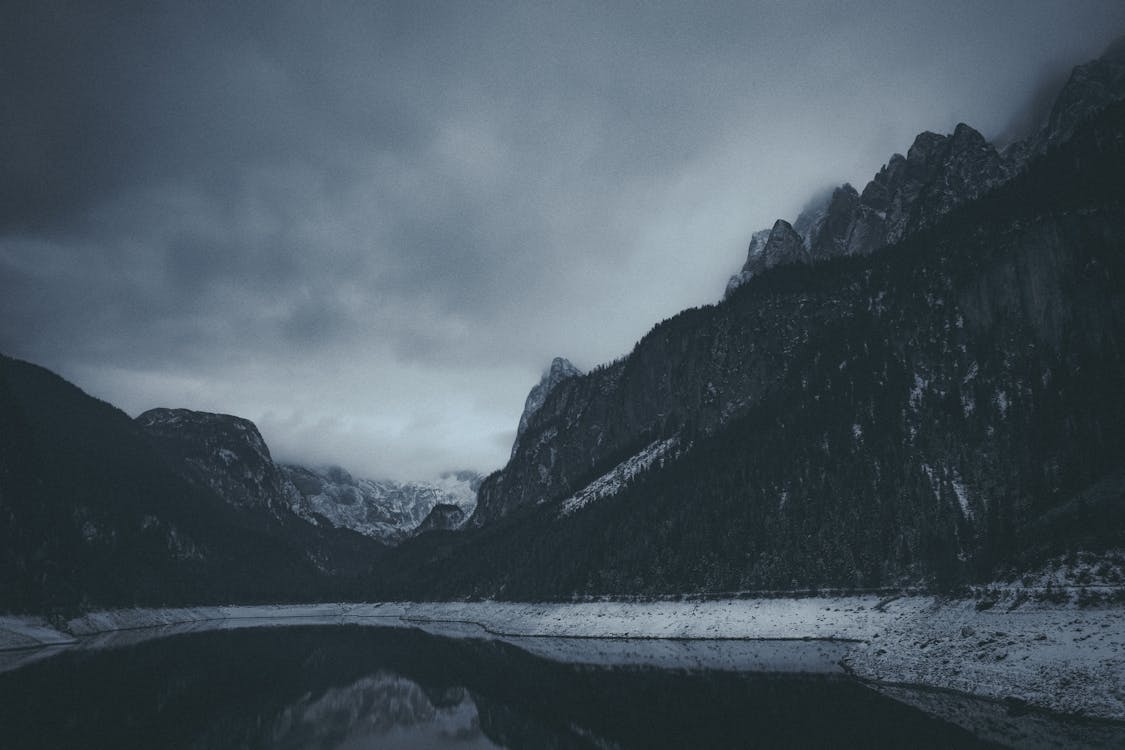 Dark Landscape with a Lake and Rocky Mountains in Mist · Free