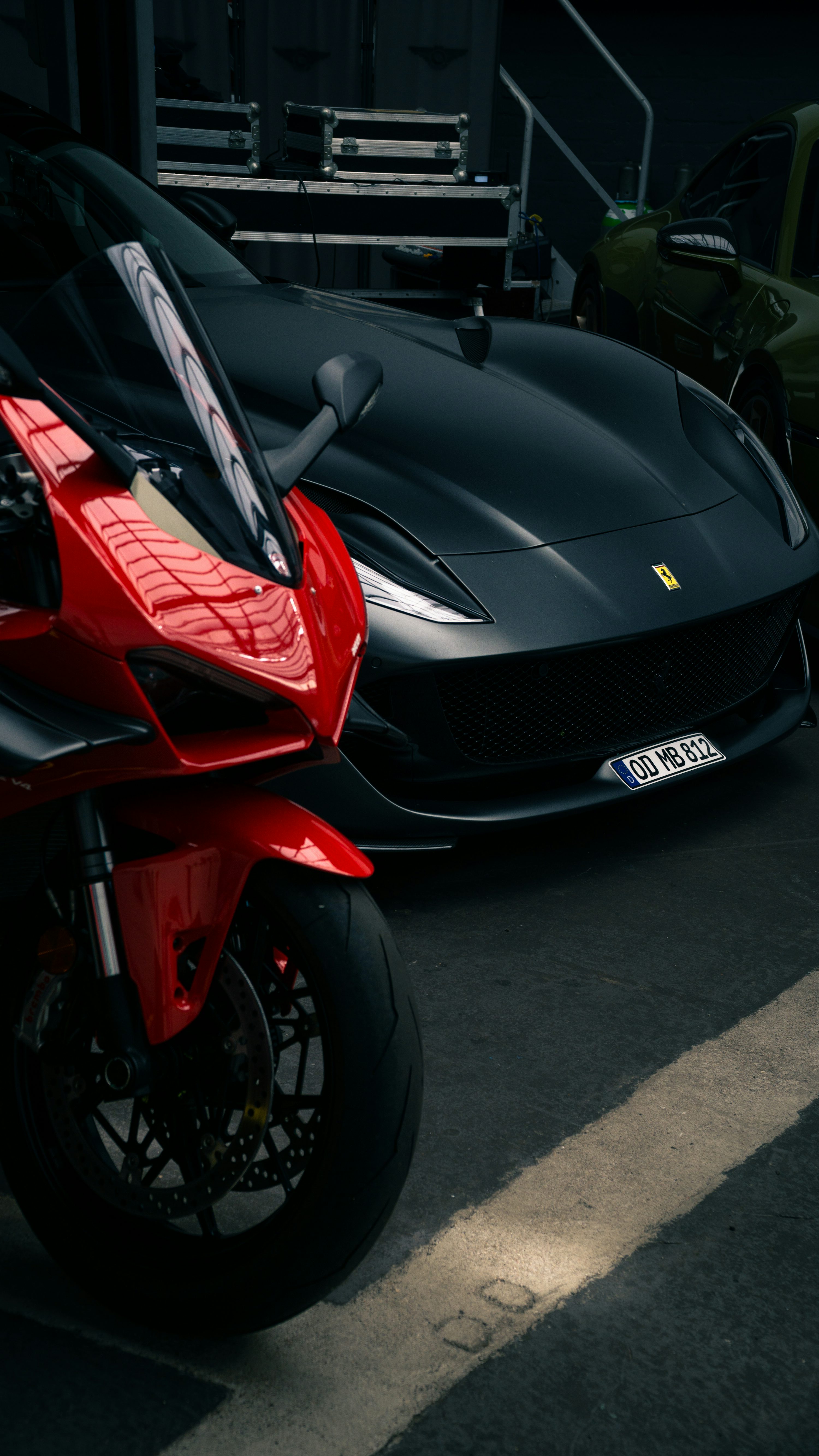 A red motorcycle parked next to a black