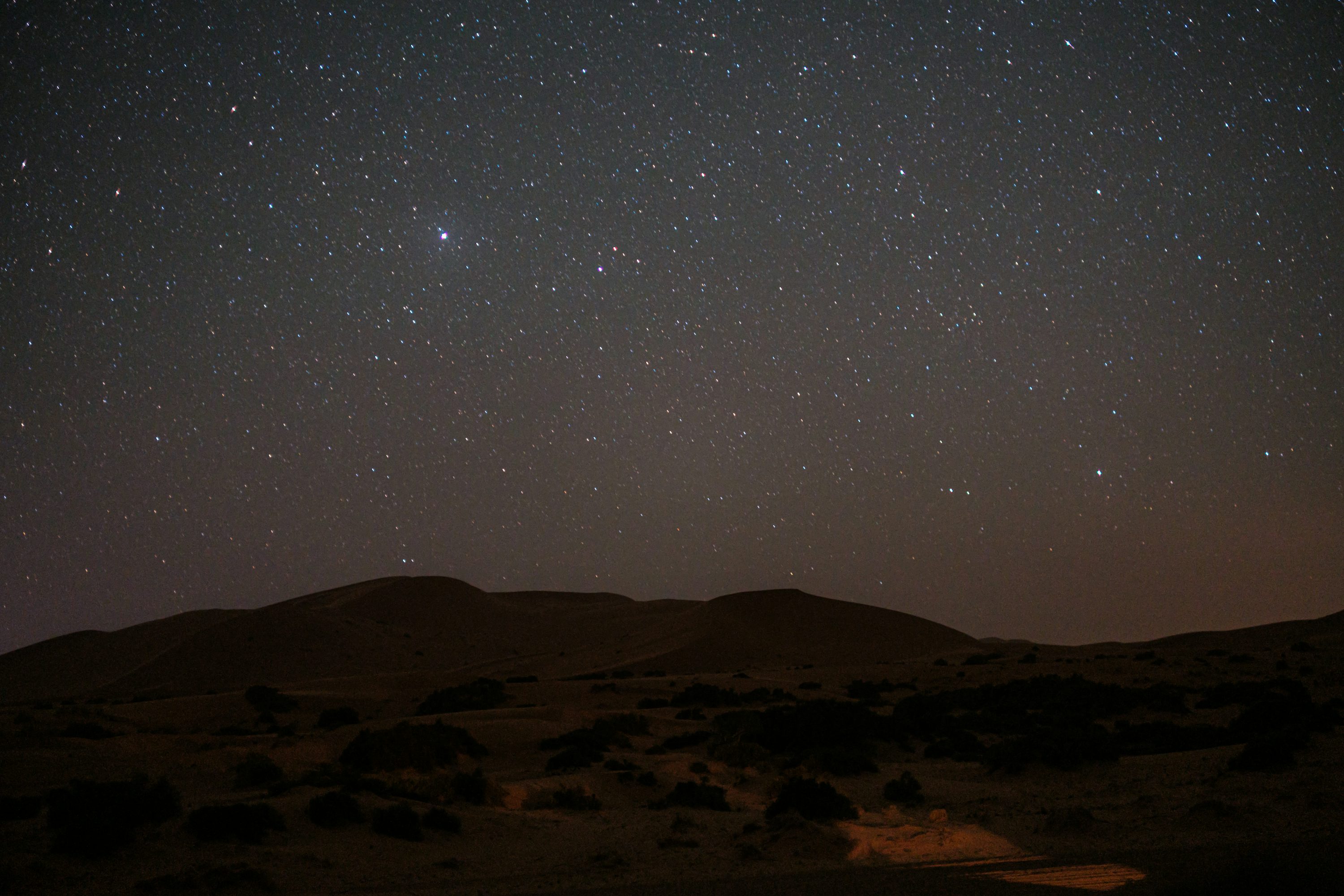 The night sky with stars above a desert