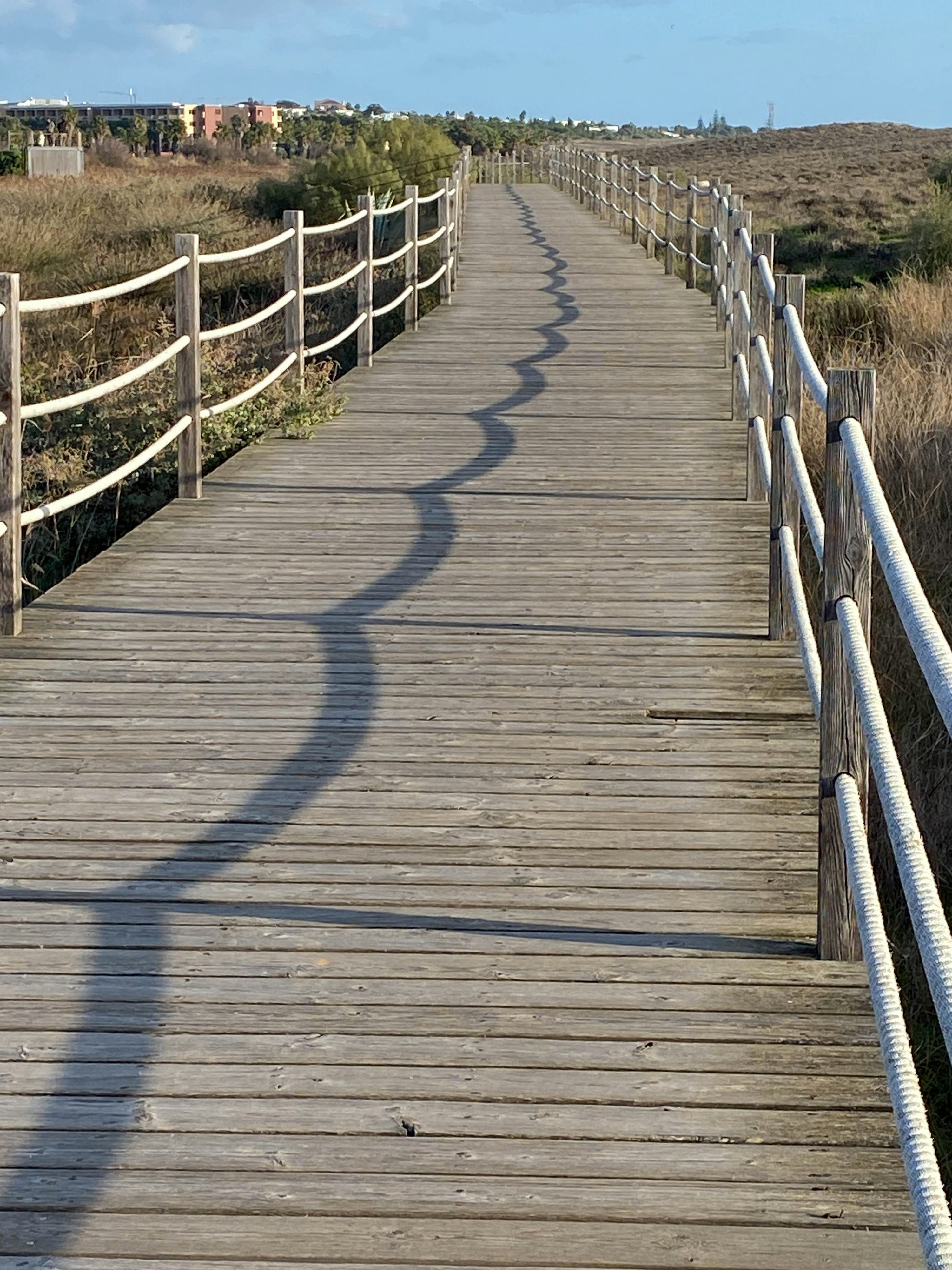 A wooden bridge with a railing photo