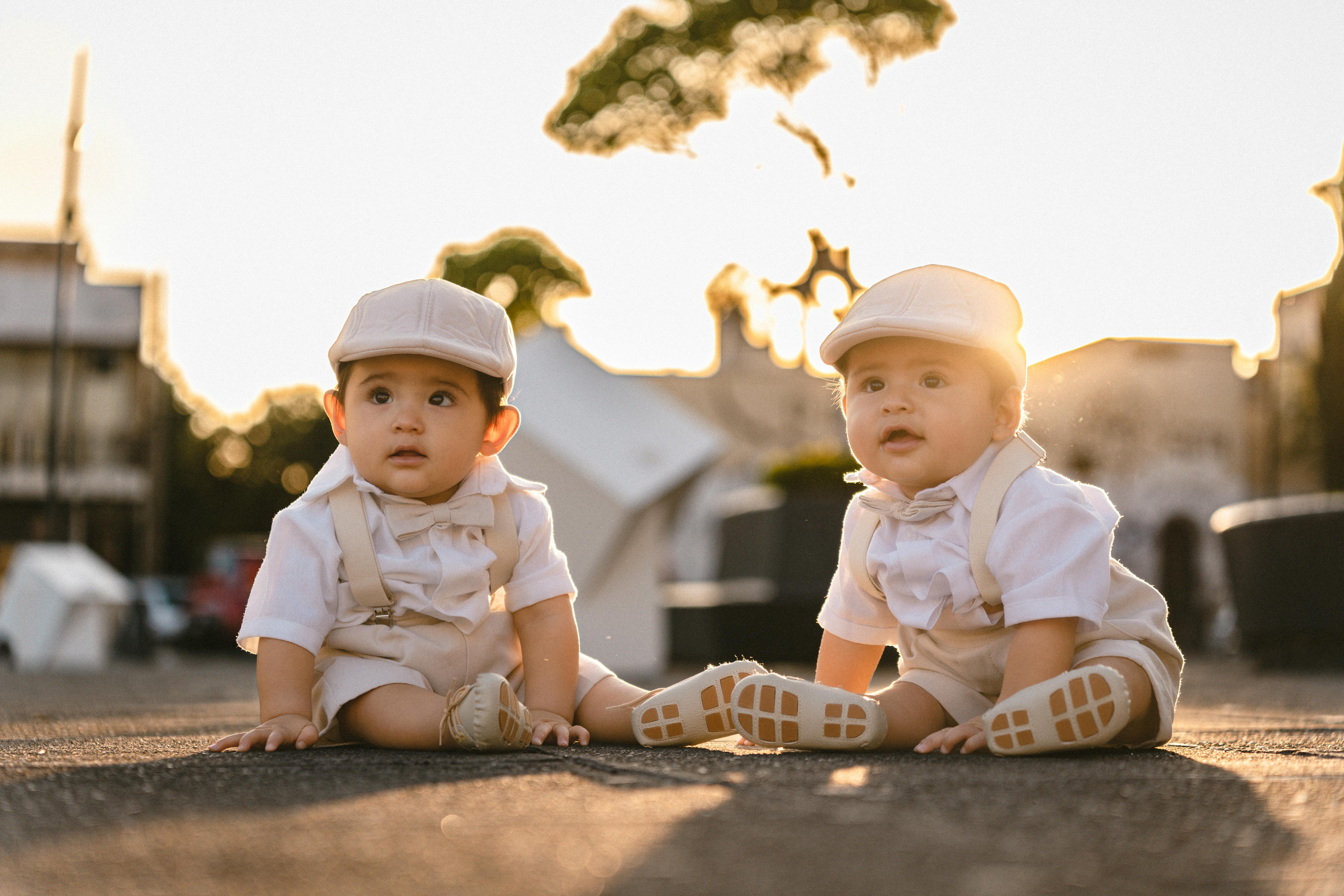 Baby Twins in Matching Outfits Sitting