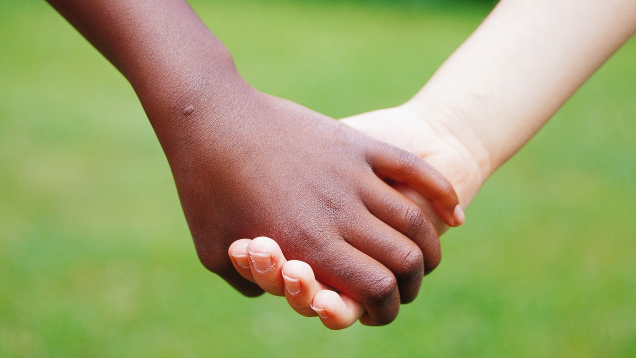 White Babies Holding Hands