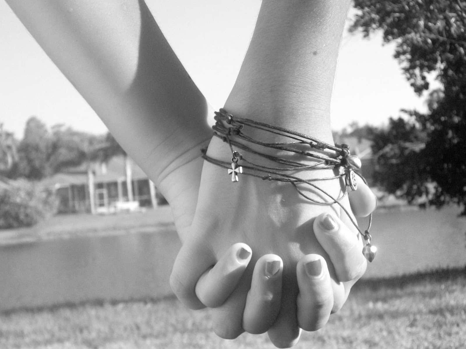 Photo Of Two People Holding Hands