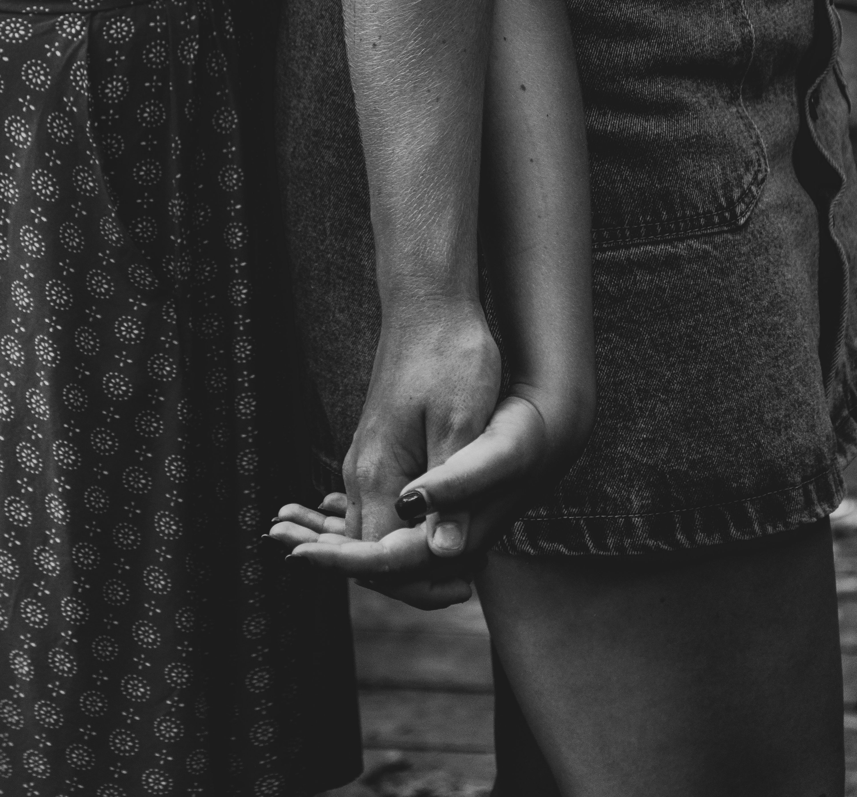 white photo of two people holding hands
