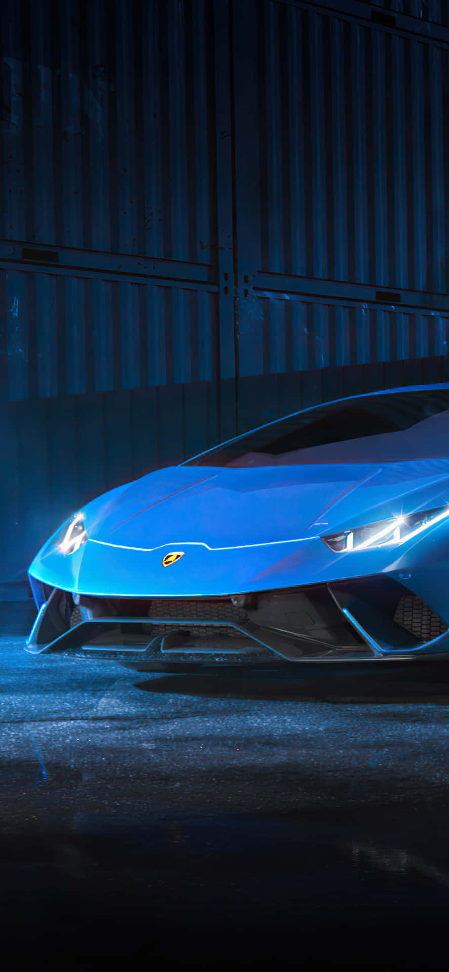 Download The Blue Lamborghini Huracan Is Shown In The Dark Wallpaper