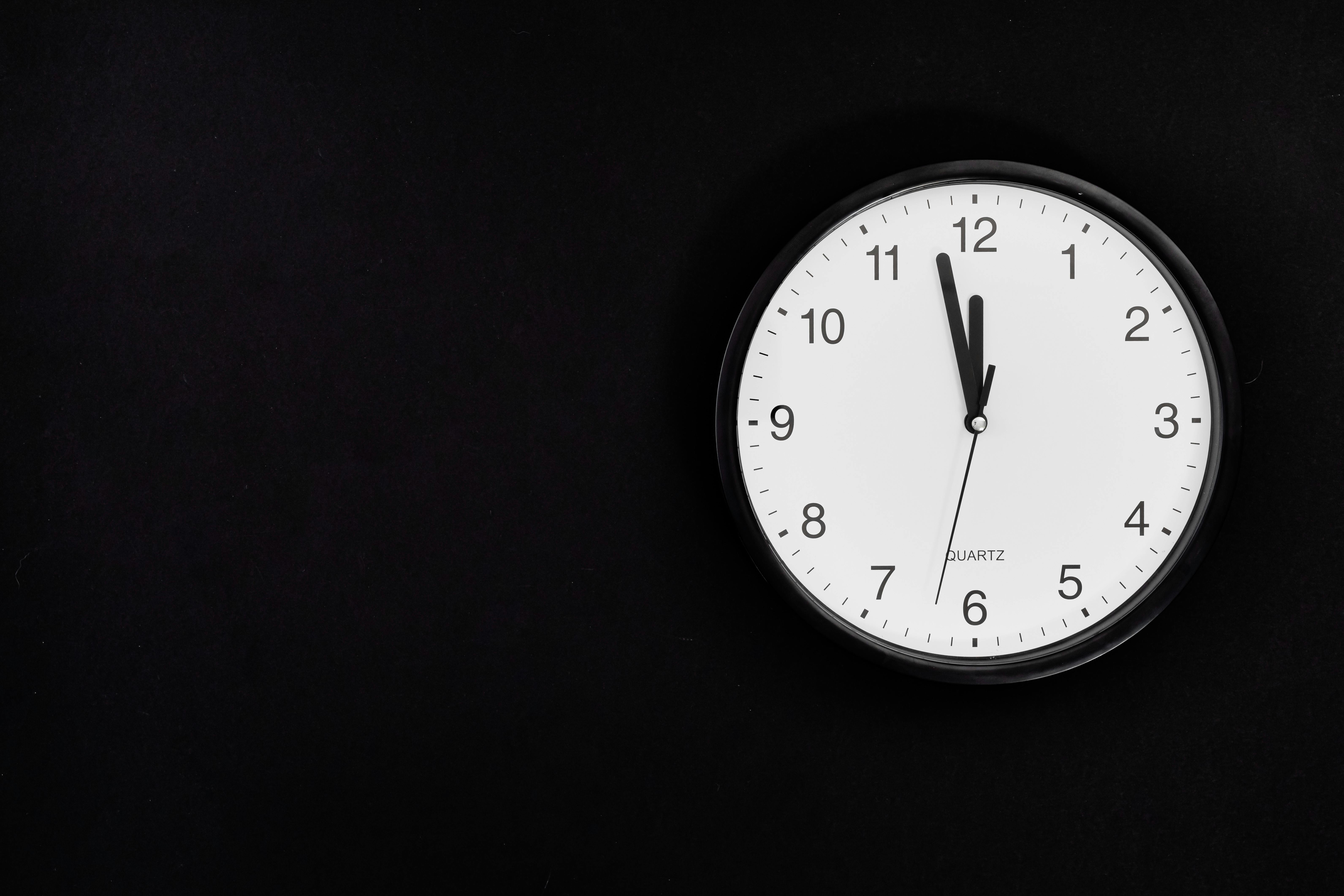 Analog Wall Clock On Black Background