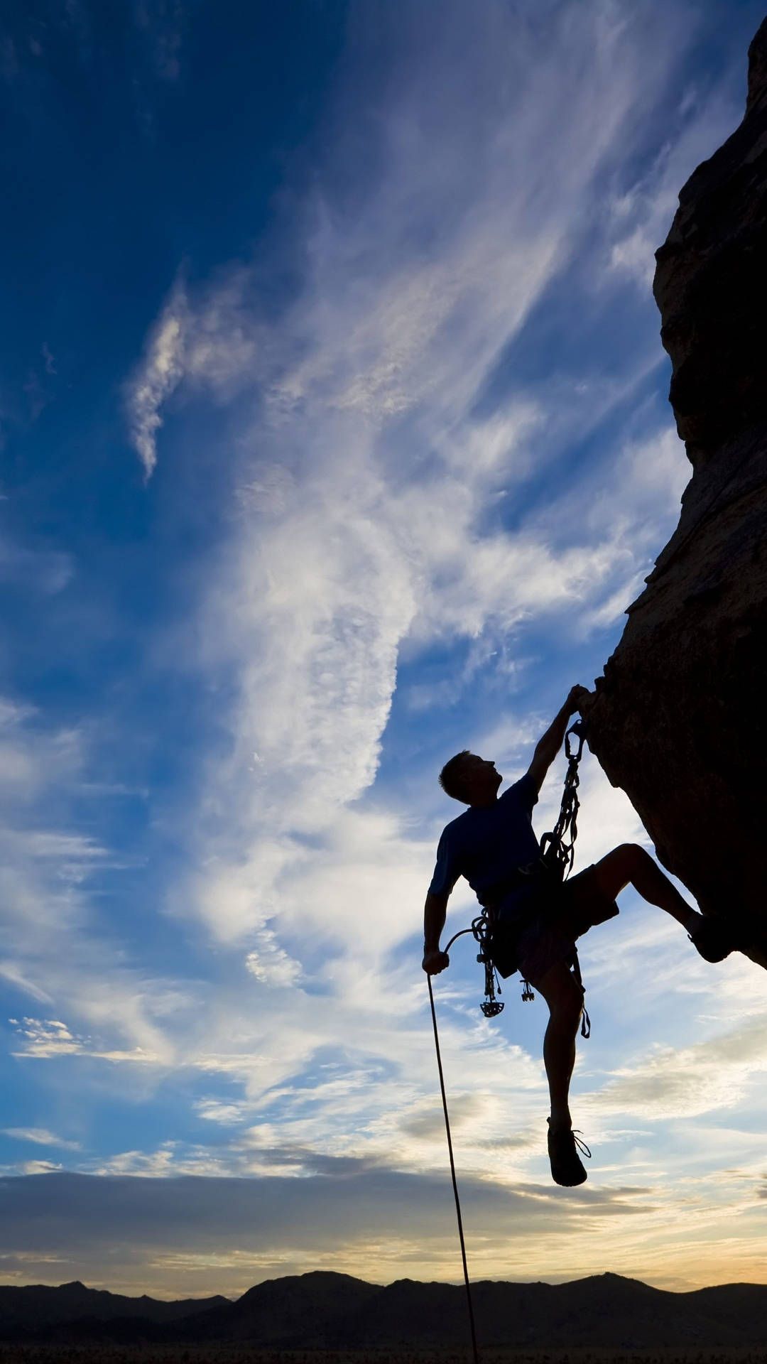 Download Silhouetted Man Climbing A