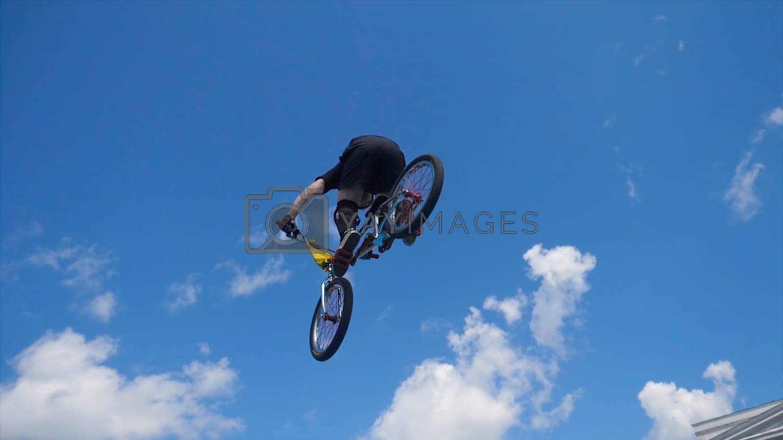 Young man on BMX bike jumps. Man doing