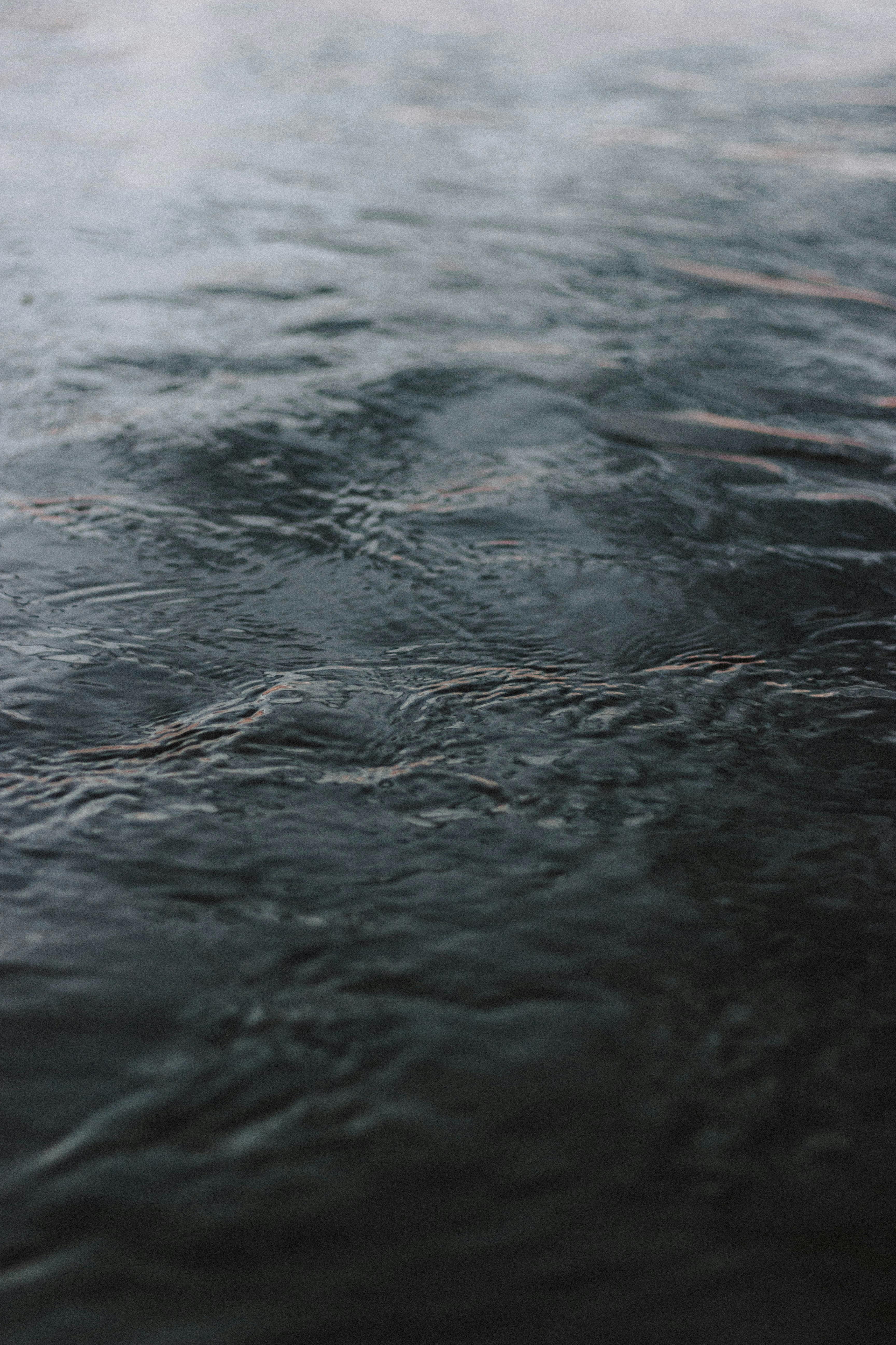 Ripple on dark water in daylight · Free