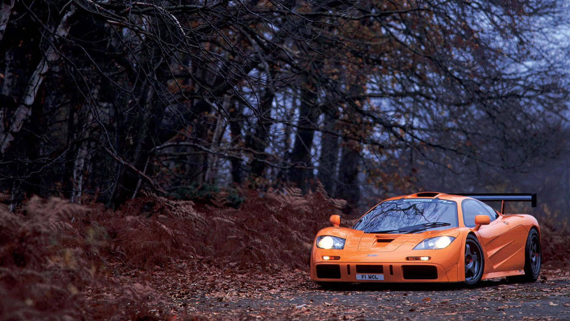 Download Sleek McLaren F1 Speeding on a
