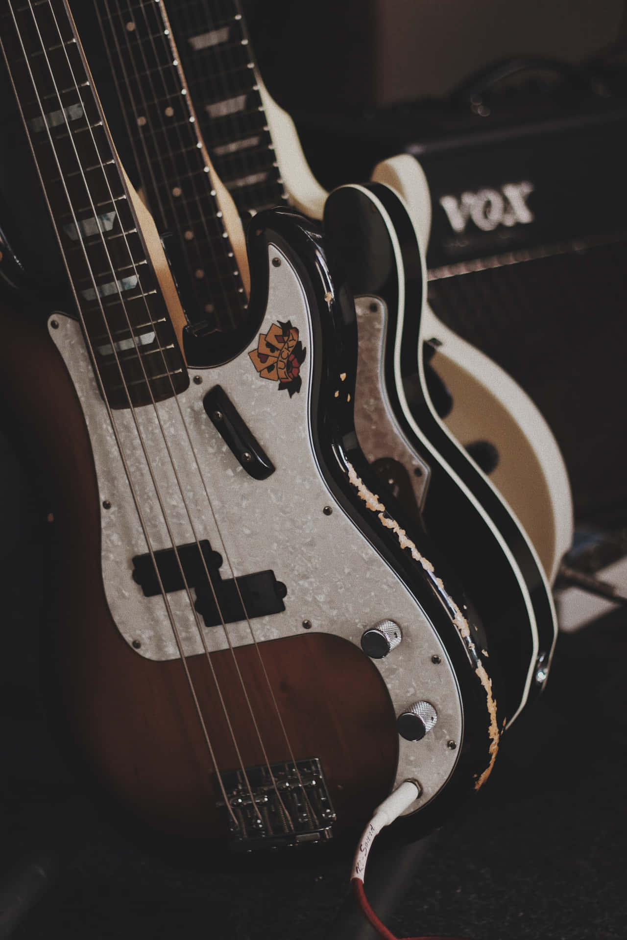 Guitars Sitting On A Table Wallpaper