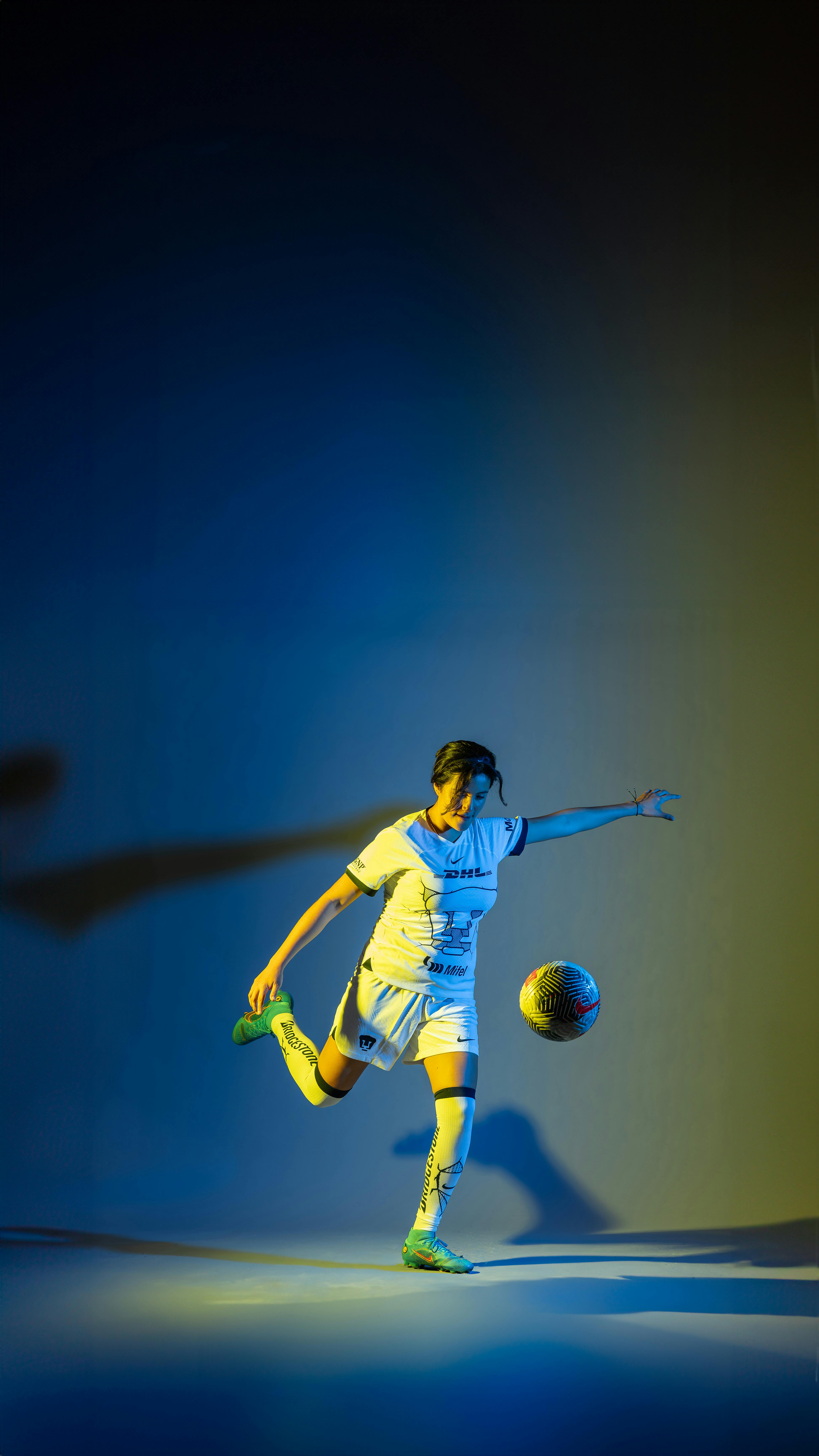 A Soccer Player Kicking the Ball · Free