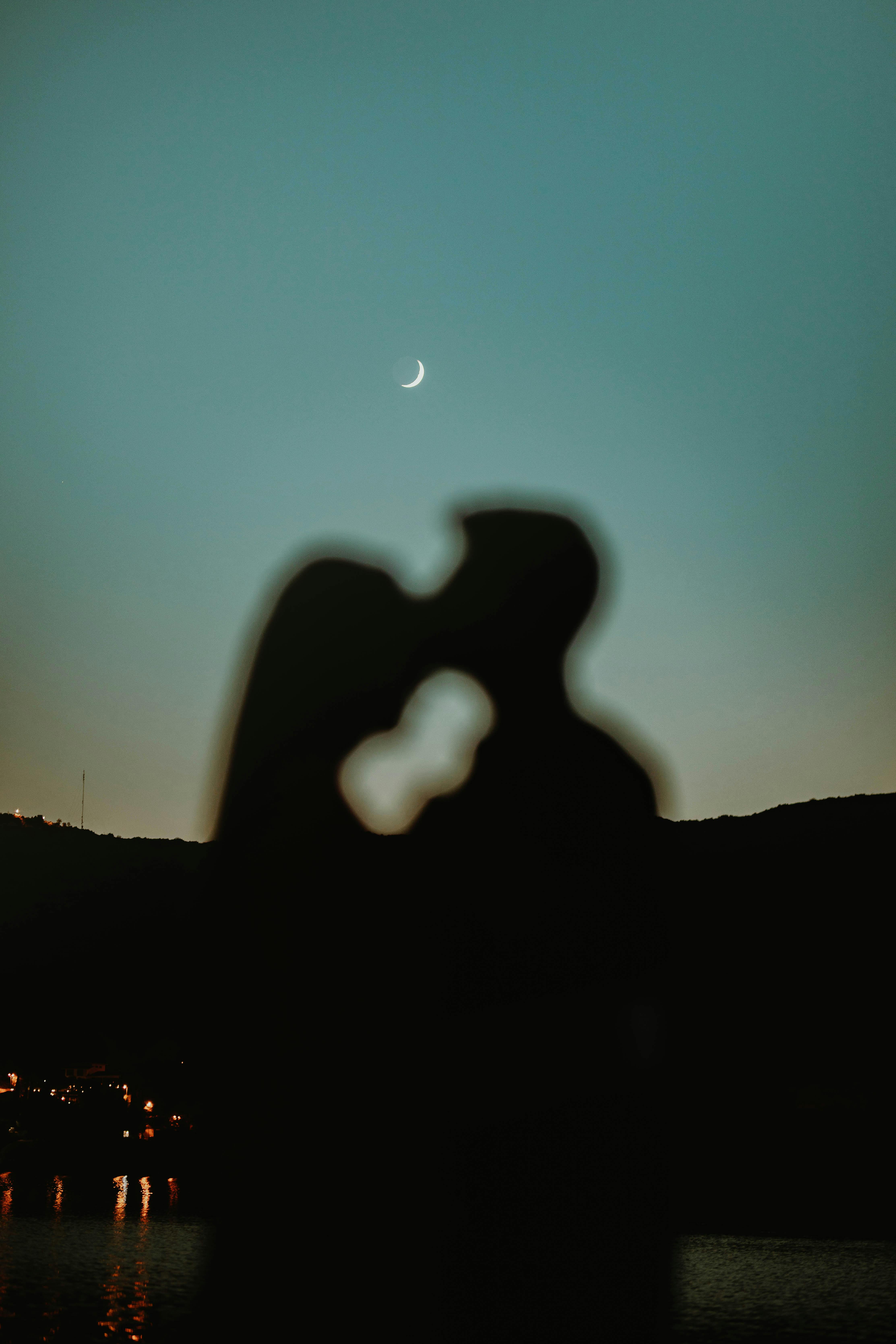 Silhouette of a Man Kissing a Woman