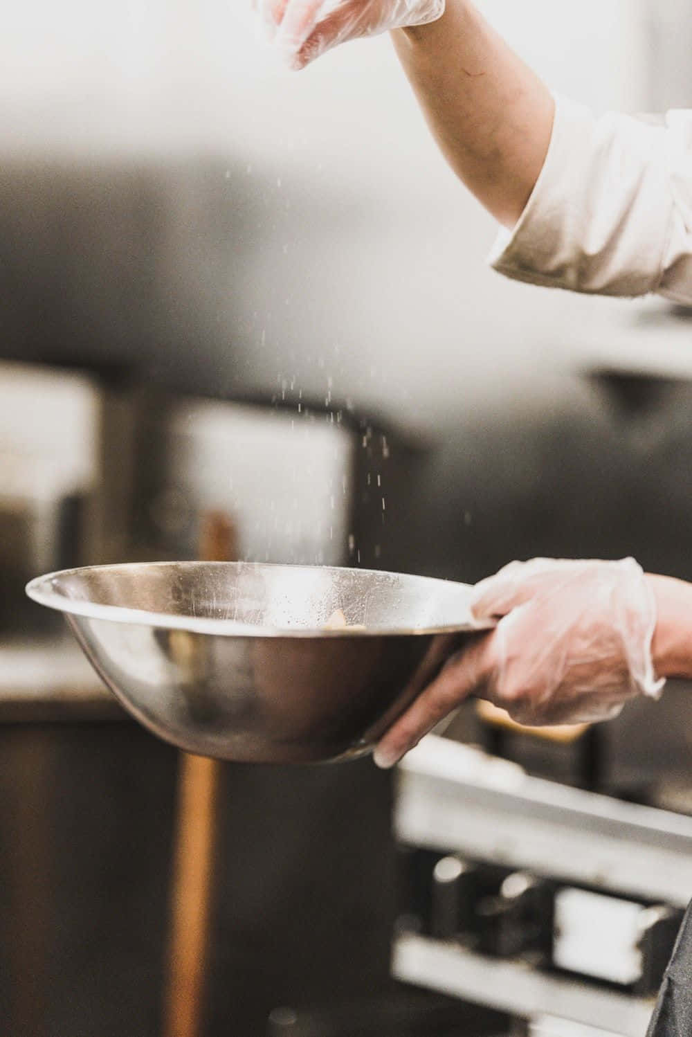 Chef Pouring A Bowl Of Flour Into A Pan
